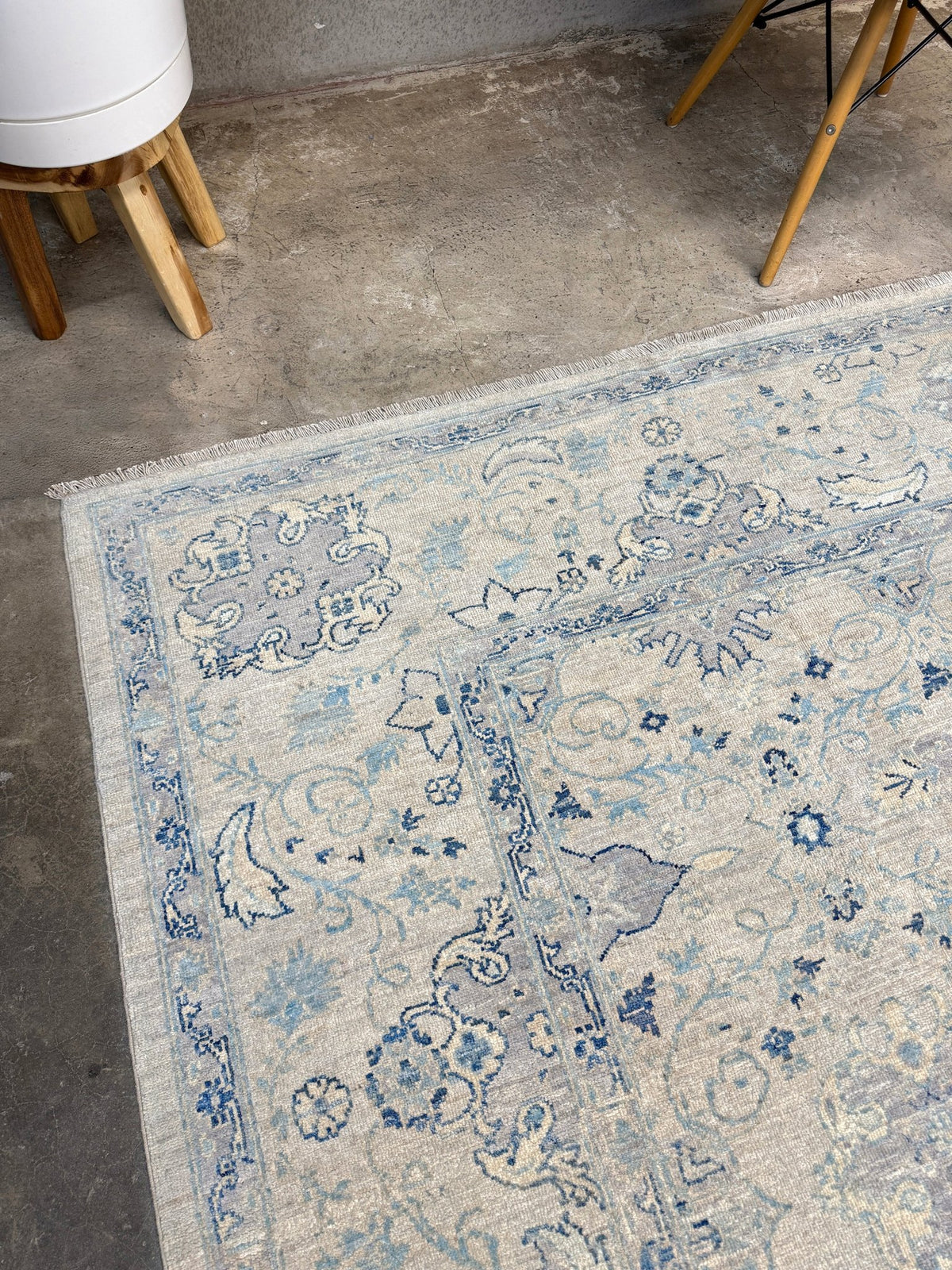 Neutral blue Oushak Turkish rug with ivory and pale blue-gray field, soft floral motifs, muted border, beige and deeper blue accents, handmade wool 8x10 from Indigo Rugs Burlingame Bay Area.