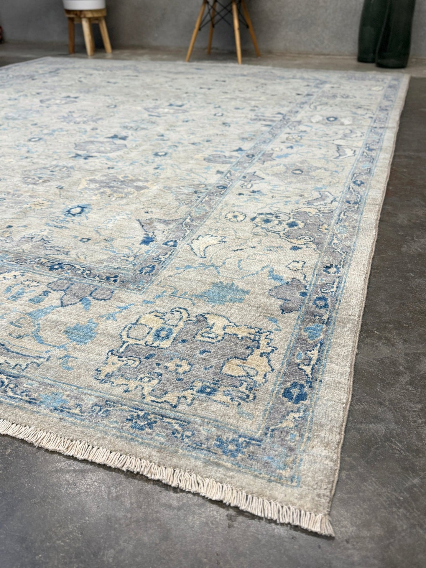 Neutral transitional handmade 8x10 decorative rug with muted gray, ivory, and layered blue tones. Soft Sultanabad-inspired floral motifs, perfect for living rooms, dining spaces, or bedrooms. Contemporary yet timeless, from a rug shop in Burlingame, San Francisco Bay Area, CA with free shipping.