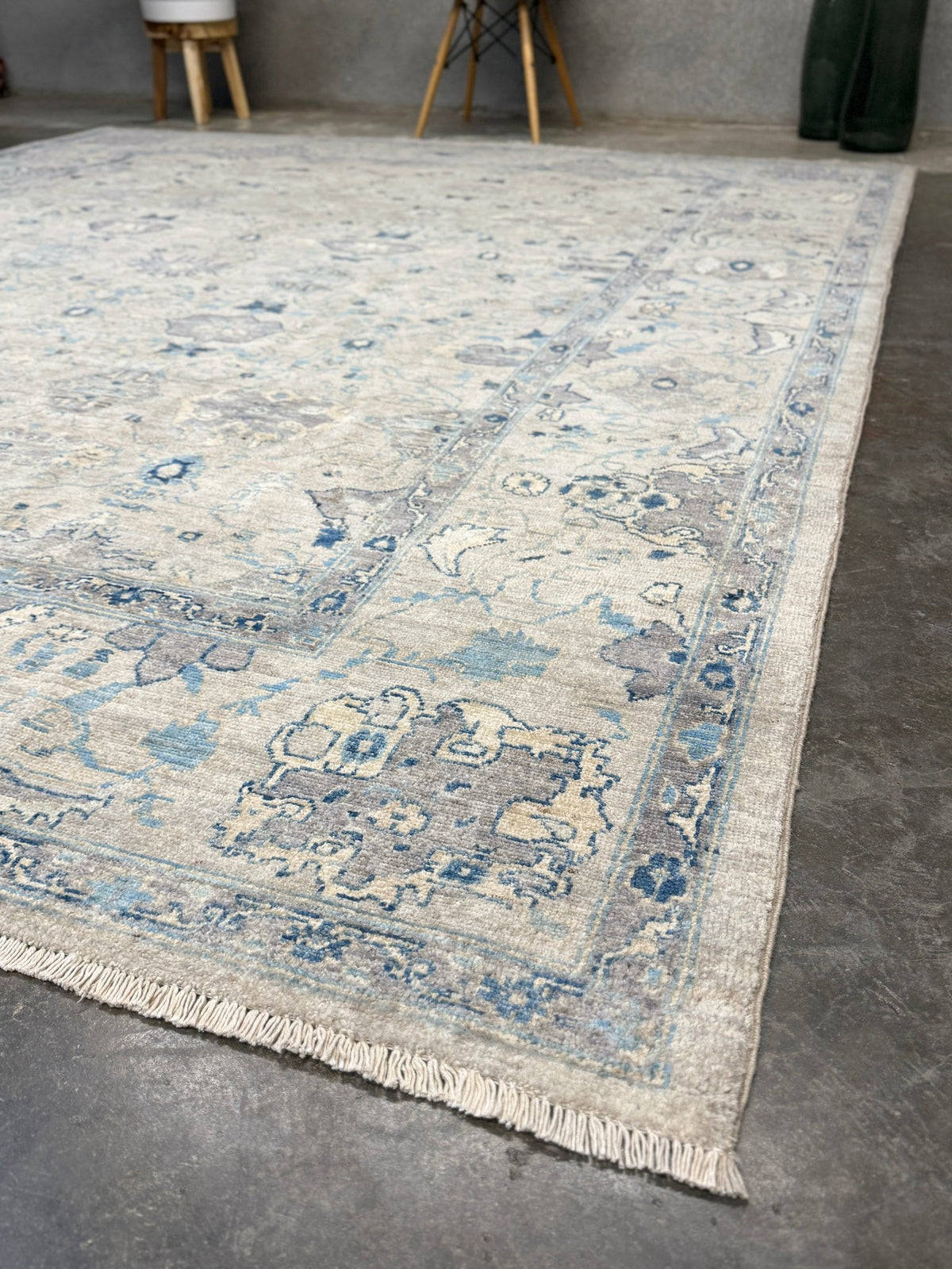Neutral blue Oushak Turkish rug with ivory and pale blue-gray field, soft floral motifs, muted border, beige and deeper blue accents, handmade wool 8x10 from Indigo Rugs Burlingame Bay Area.