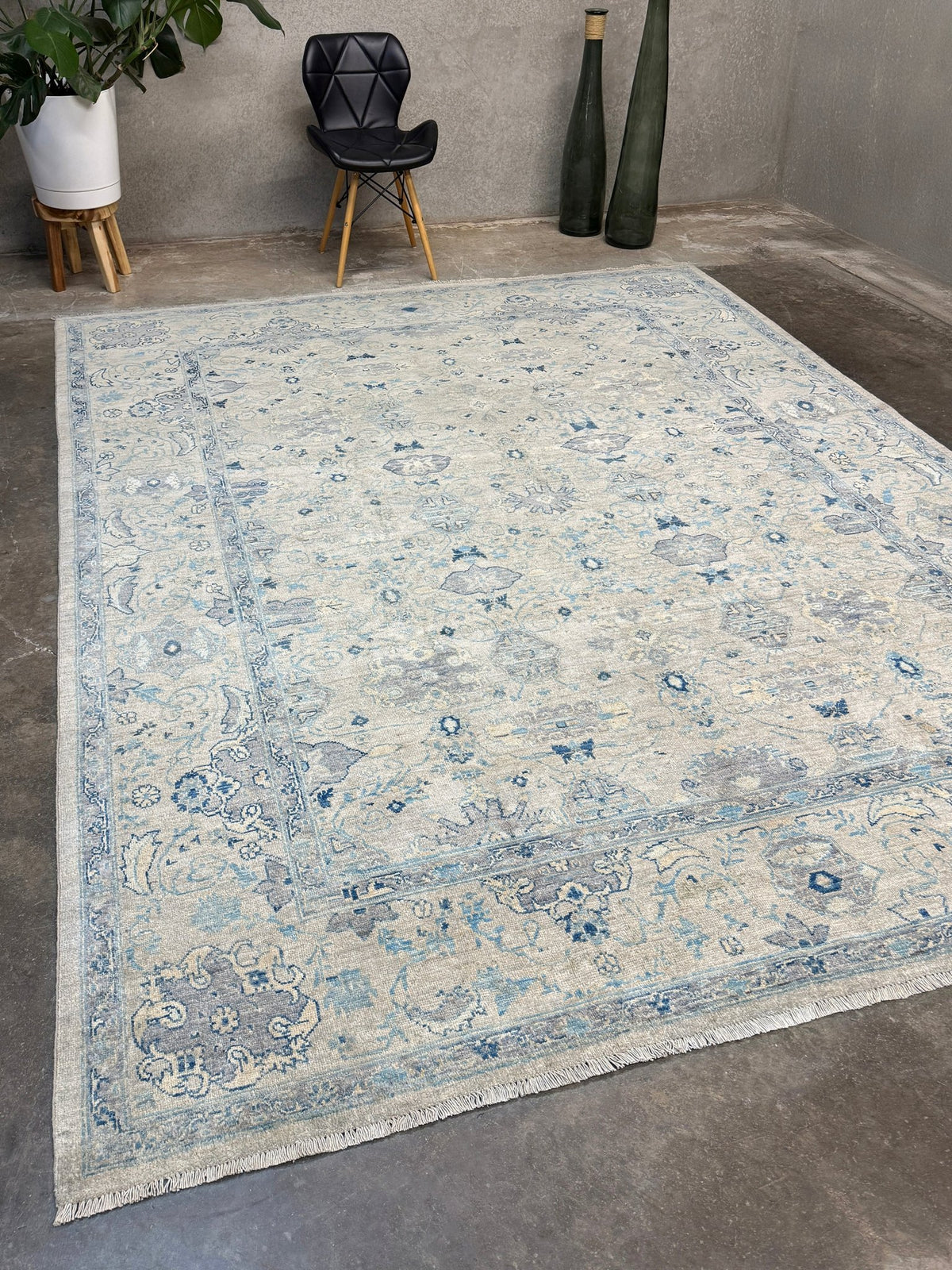 Neutral blue Oushak Turkish rug with ivory and pale blue-gray field, soft floral motifs, muted border, beige and deeper blue accents, handmade wool 8x10 from Indigo Rugs Burlingame Bay Area.