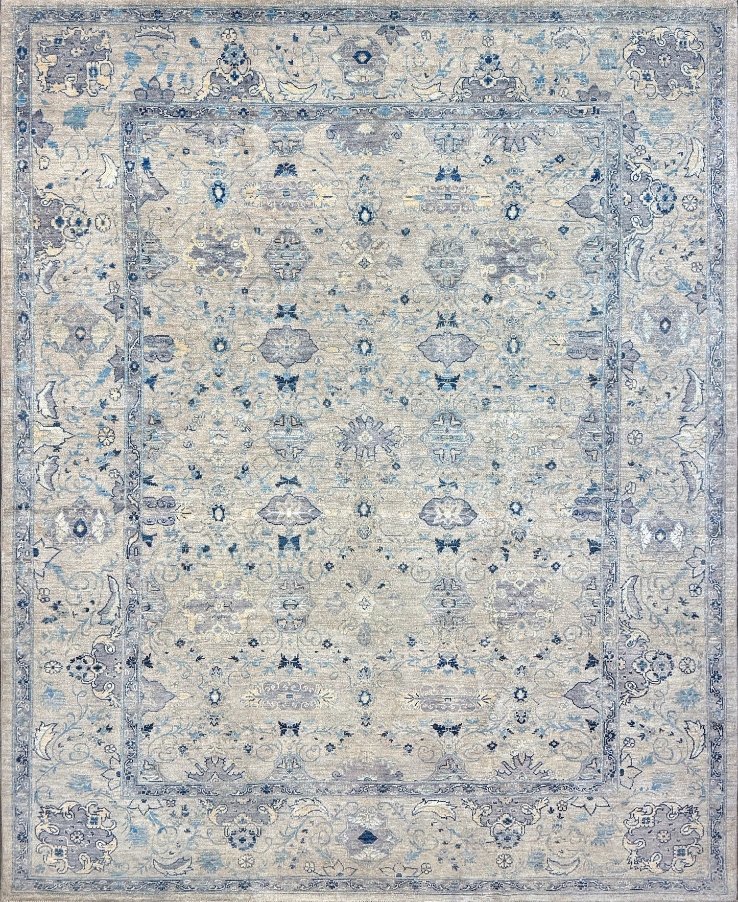 Neutral transitional handmade 8x10 rug with muted gray, ivory, and layered blue tones. Soft Sultanabad-inspired floral motifs, perfect for living rooms, dining spaces, or bedrooms. Contemporary yet timeless, from a rug shop in Burlingame, San Francisco Bay Area, CA with free shipping.