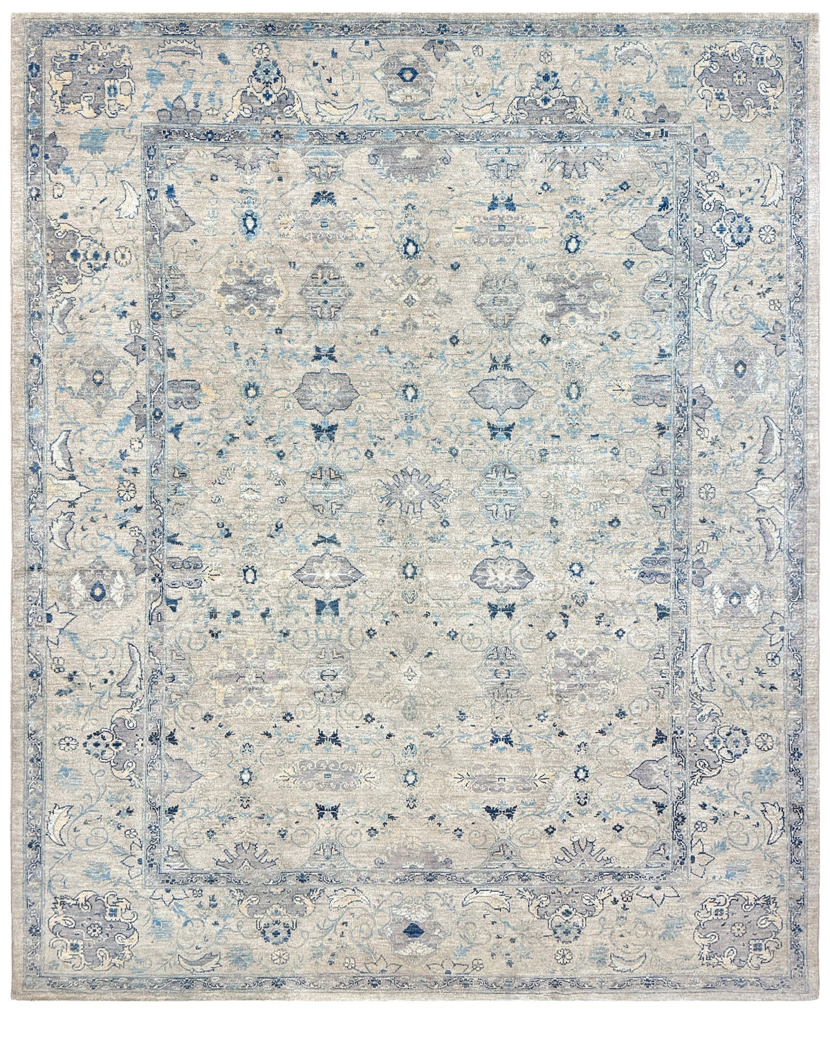 Neutral blue Oushak Turkish rug with ivory and pale blue-gray field, soft floral motifs, muted border, beige and deeper blue accents, handmade wool 8x10 from Indigo Rugs Burlingame Bay Area.