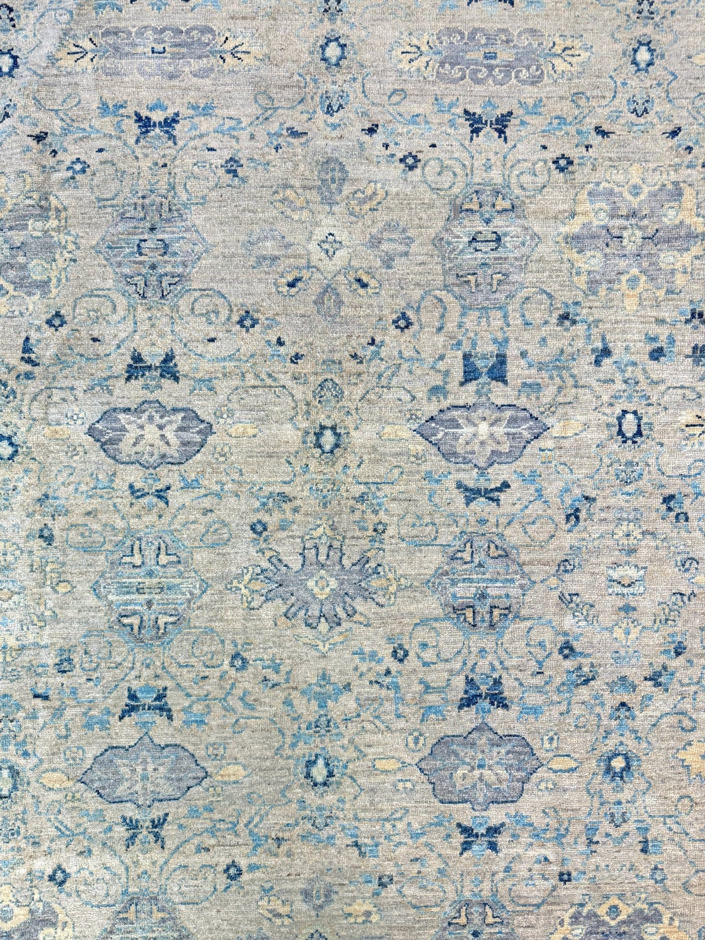 Neutral transitional handmade 8x10 decorative rug with muted gray, ivory, and layered blue tones. Soft Sultanabad-inspired floral motifs, perfect for living rooms, dining spaces, or bedrooms. Contemporary yet timeless, from a rug shop in Burlingame, San Francisco Bay Area, CA with free shipping.