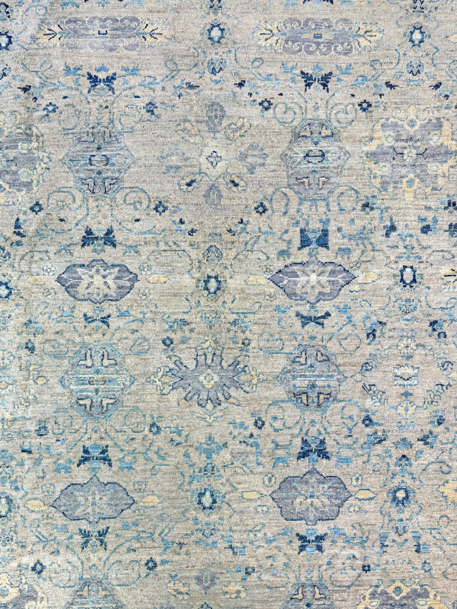 Neutral transitional handmade 8x10 decorative rug with muted gray, ivory, and layered blue tones. Soft Sultanabad-inspired floral motifs, perfect for living rooms, dining spaces, or bedrooms. Contemporary yet timeless, from a rug shop in Burlingame, San Francisco Bay Area, CA with free shipping.