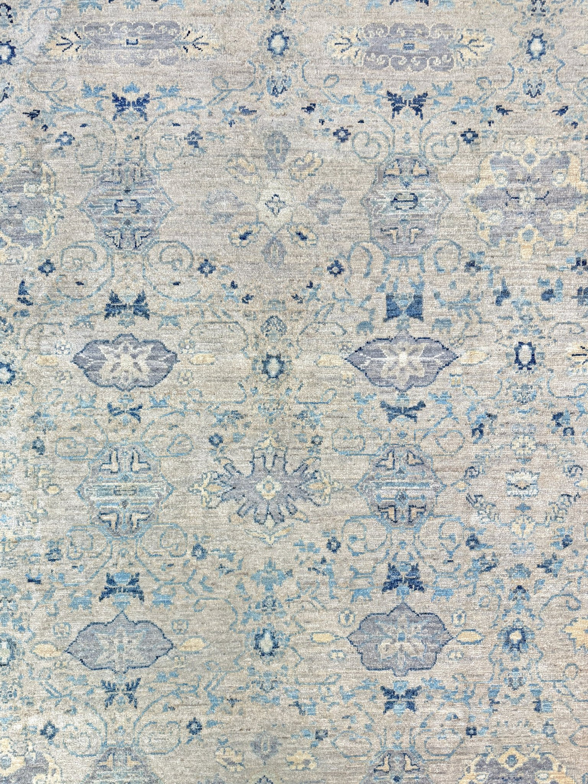 Neutral blue Oushak Turkish rug with ivory and pale blue-gray field, soft floral motifs, muted border, beige and deeper blue accents, handmade wool 8x10 from Indigo Rugs Burlingame Bay Area.