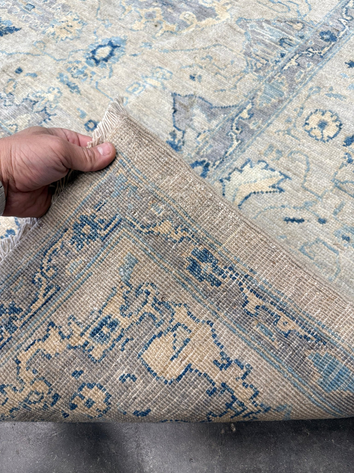 Neutral blue Oushak Turkish rug with ivory and pale blue-gray field, soft floral motifs, muted border, beige and deeper blue accents, handmade wool 8x10 from Indigo Rugs Burlingame Bay Area.