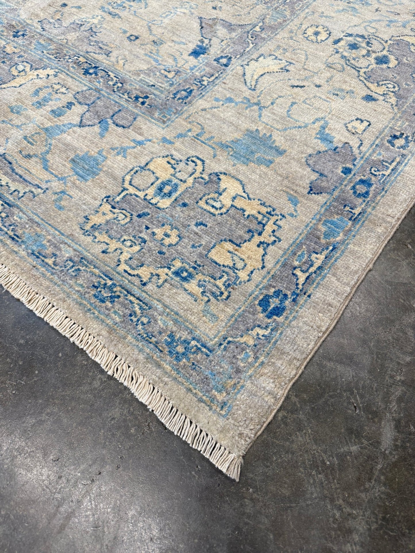 Neutral transitional handmade 8x10 decorative rug with muted gray, ivory, and layered blue tones. Soft Sultanabad-inspired floral motifs, perfect for living rooms, dining spaces, or bedrooms. Contemporary yet timeless, from a rug shop in Burlingame, San Francisco Bay Area, CA with free shipping.
