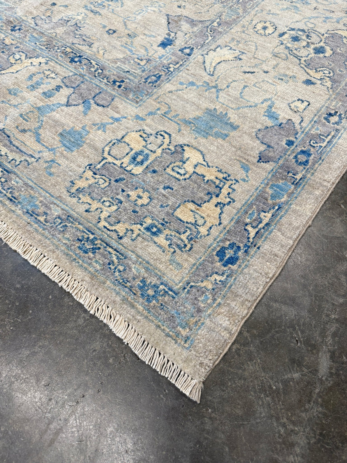 Neutral blue Oushak Turkish rug with ivory and pale blue-gray field, soft floral motifs, muted border, beige and deeper blue accents, handmade wool 8x10 from Indigo Rugs Burlingame Bay Area.