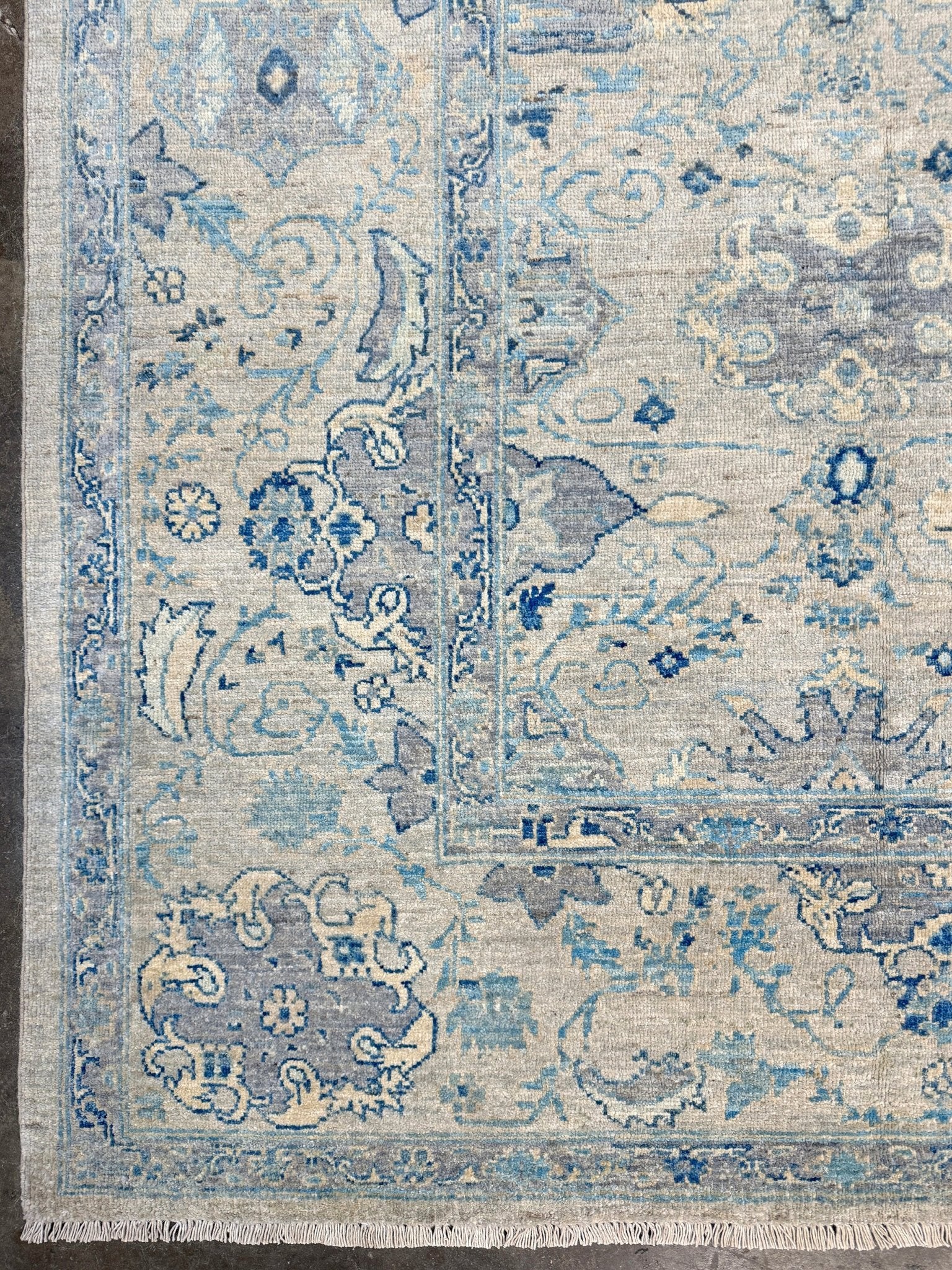 Neutral transitional handmade 8x10 decorative rug with muted gray, ivory, and layered blue tones. Soft Sultanabad-inspired floral motifs, perfect for living rooms, dining spaces, or bedrooms. Contemporary yet timeless, from a rug shop in Burlingame, San Francisco Bay Area, CA with free shipping.