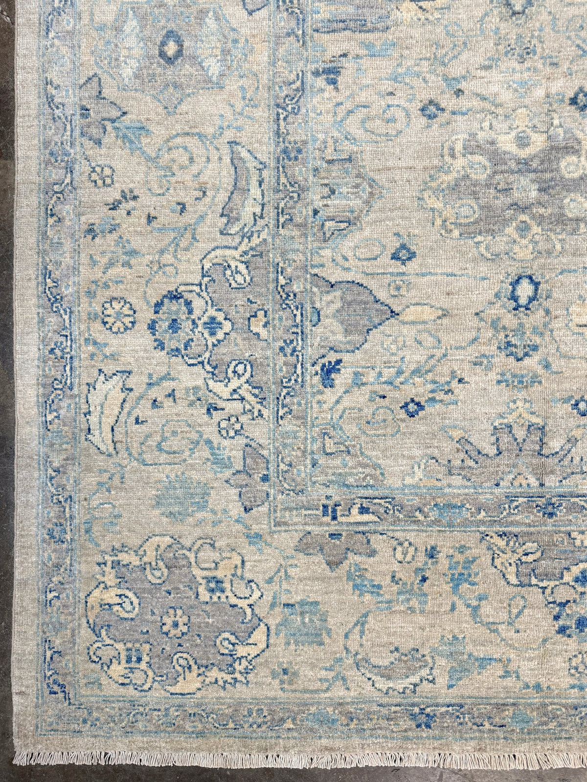 Neutral blue Oushak Turkish rug with ivory and pale blue-gray field, soft floral motifs, muted border, beige and deeper blue accents, handmade wool 8x10 from Indigo Rugs Burlingame Bay Area.