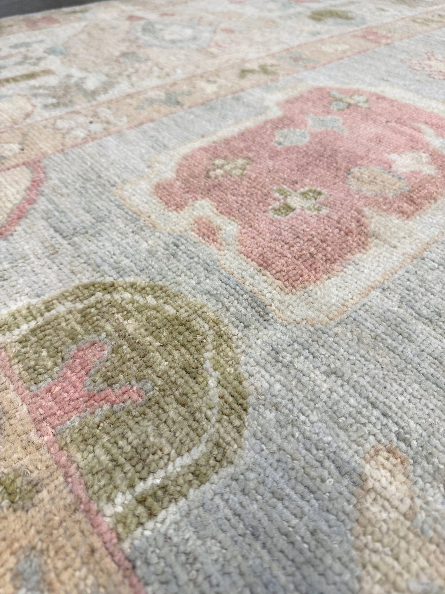 Close-up 8x10 handmade Turkish Oushak rug with muted silver-gray and blush palette, transitional design perfect for living room, bedroom, or dining room décor. Available at Indigo Rugs, Burlingame – best rug shop in the SF Bay Area. Free shipping.