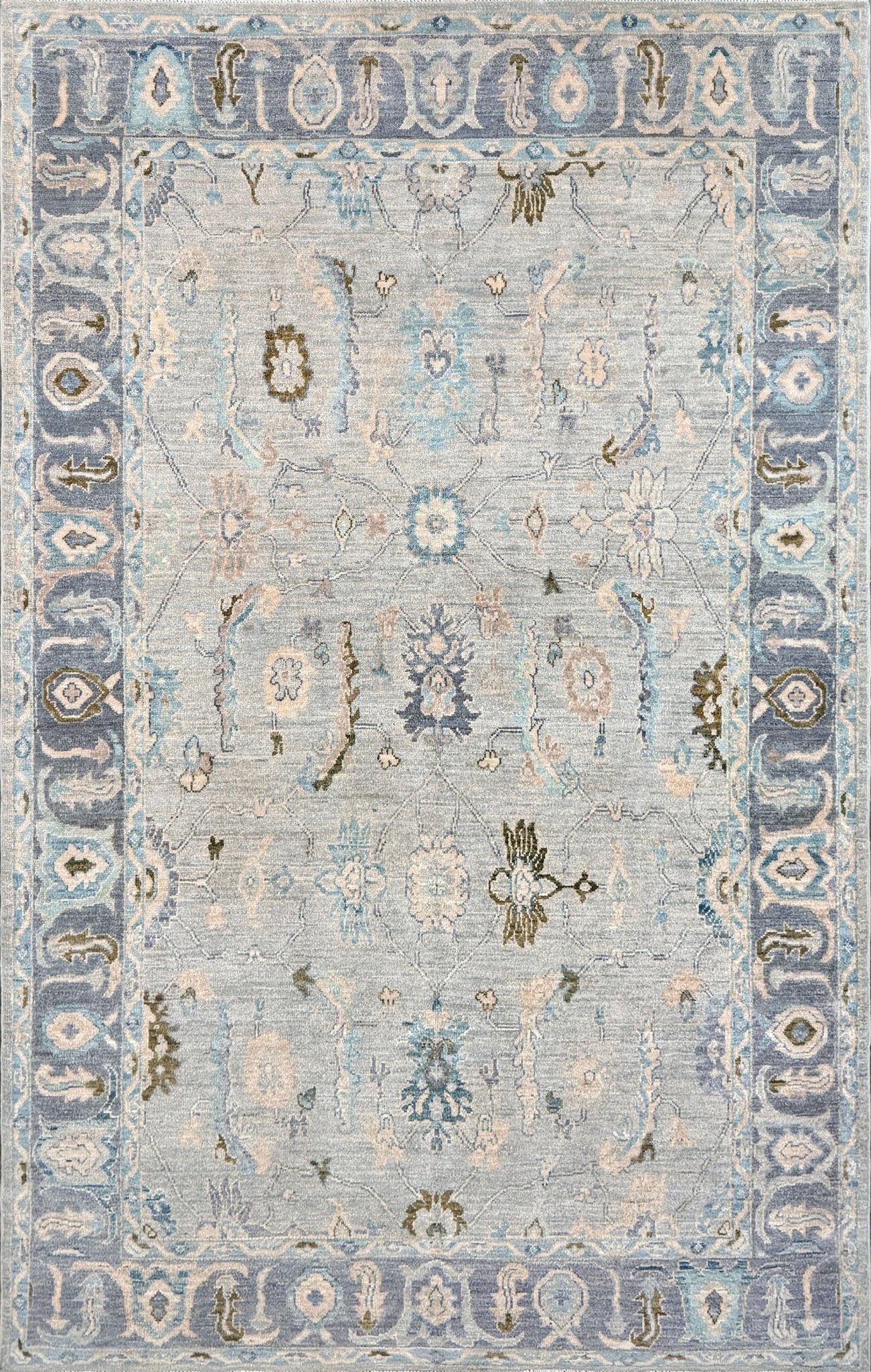 Handmade transitional 6x9 Turkish Oushak rug in silvery gray, powder blue, ivory, olive green, and muted lavender. Perfect for coastal, farmhouse, or light modern interiors — available at Indigo Rugs, Burlingame.
