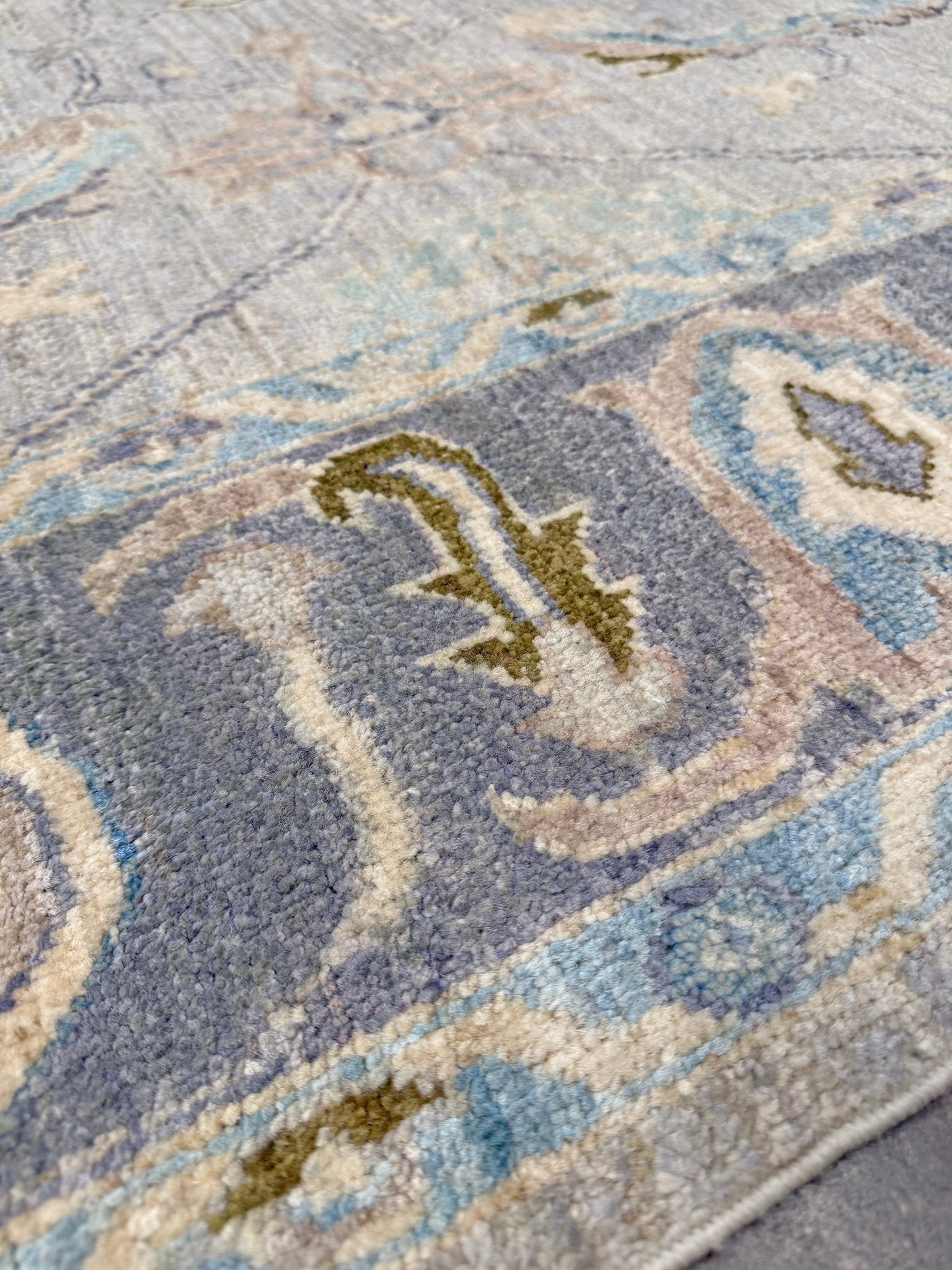 Handmade transitional 6x9 Turkish Oushak rug in silvery gray, powder blue, ivory, olive green, and muted lavender. Perfect for coastal, farmhouse, or light modern interiors — available at Indigo Rugs, Burlingame CA. Free Shipping