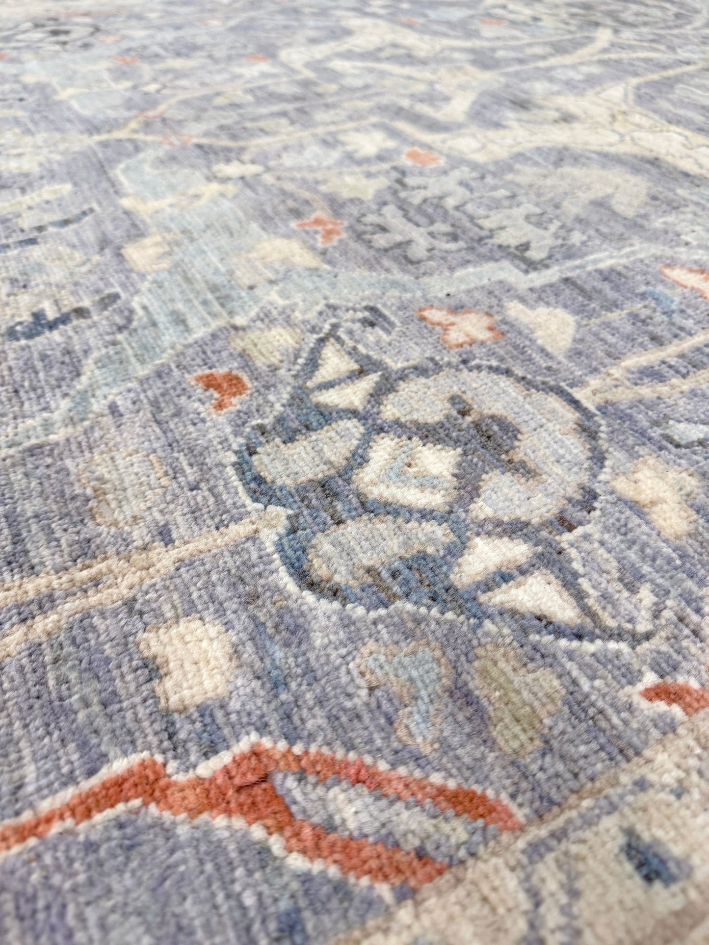 Close-up of Neutral Handmade 6x9 Arabesque Bijar Persian rug in silvery gray with blue undertone, ivory vines, muted blue details, terracotta and rust highlights, and muted midnight blue outlines – transitional Persian wool rug for living room bedroom dining. Free shipping