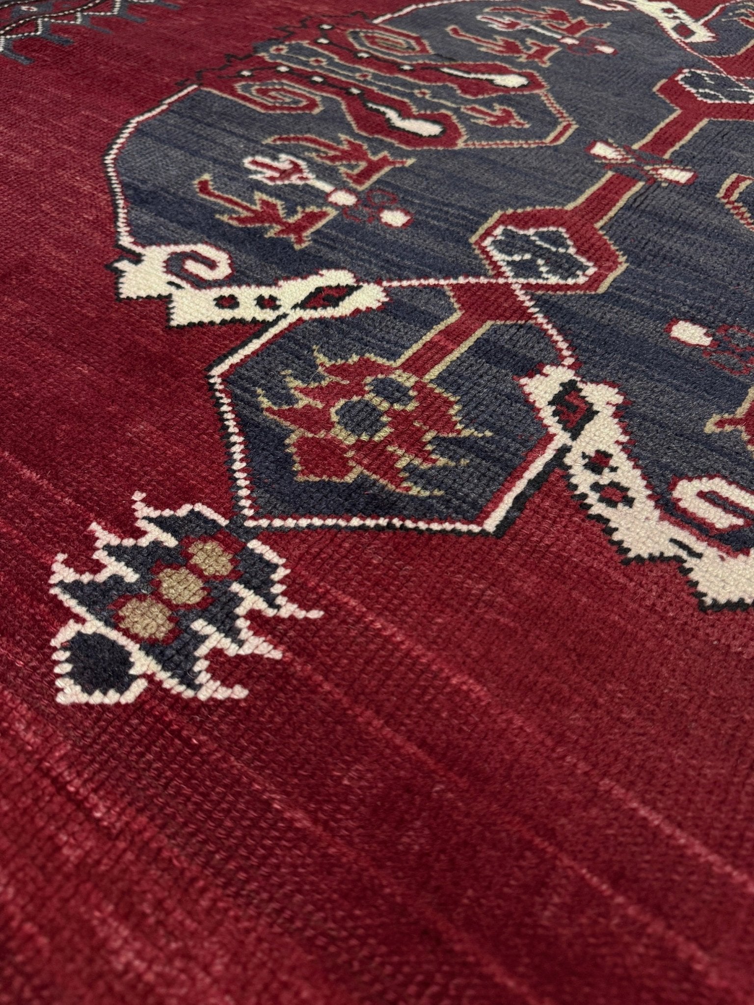 Close-up of a red and blue patterned rug with intricate designs. Antique kiz bergama turkish rug 6x8 deep madder red field indigo clue medallion anatolian village rug 1920s indigo rugs san francisco bay area