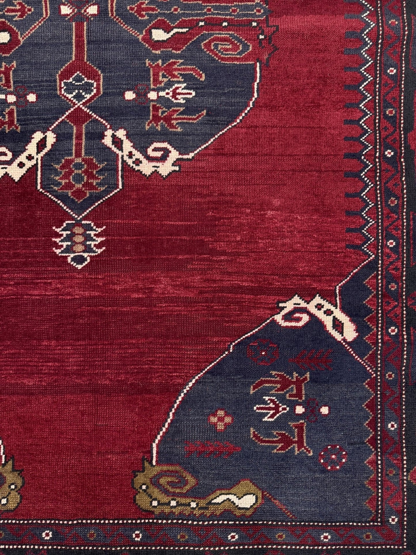 Close-up of a red and blue patterned rug with intricate designs. Antique kiz bergama turkish rug 6x8 deep madder red field indigo clue medallion anatolian village rug 1920s indigo rugs san francisco bay area