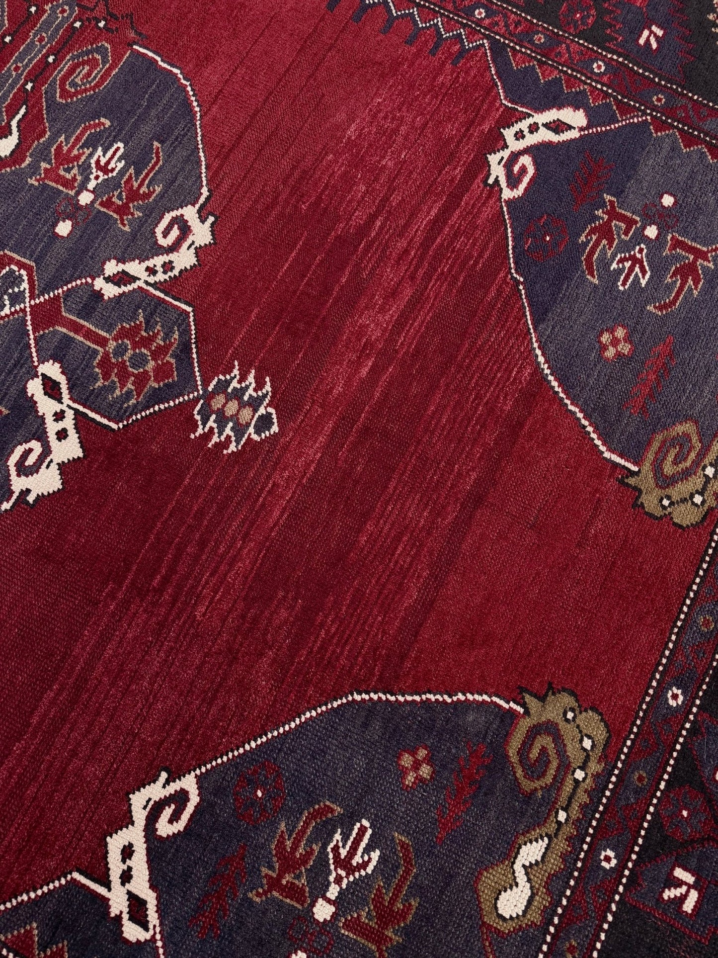 Close-up of a red patterned rug with intricate designs. Antique kiz bergama turkish rug 6x8 deep madder red field indigo clue medallion anatolian village rug 1920s indigo rugs san francisco bay area