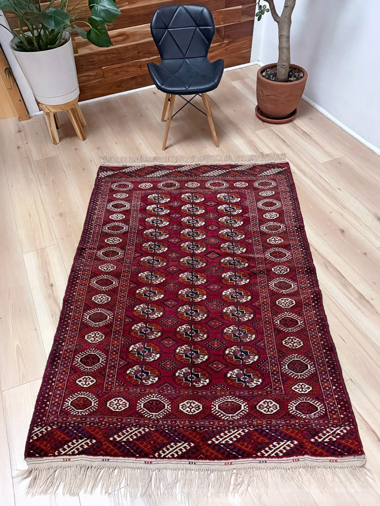 Vintage Turkmen Burgundy Bukhara rug 4x6 with repeating ivory gul motifs, velvety wool pile and classic tribal border. Hand-knotted wool scatter rug for living room bedroom office from Indigo Rugs, Burlingame — the best rug shop in the San Francisco Bay Area. Free shipping.