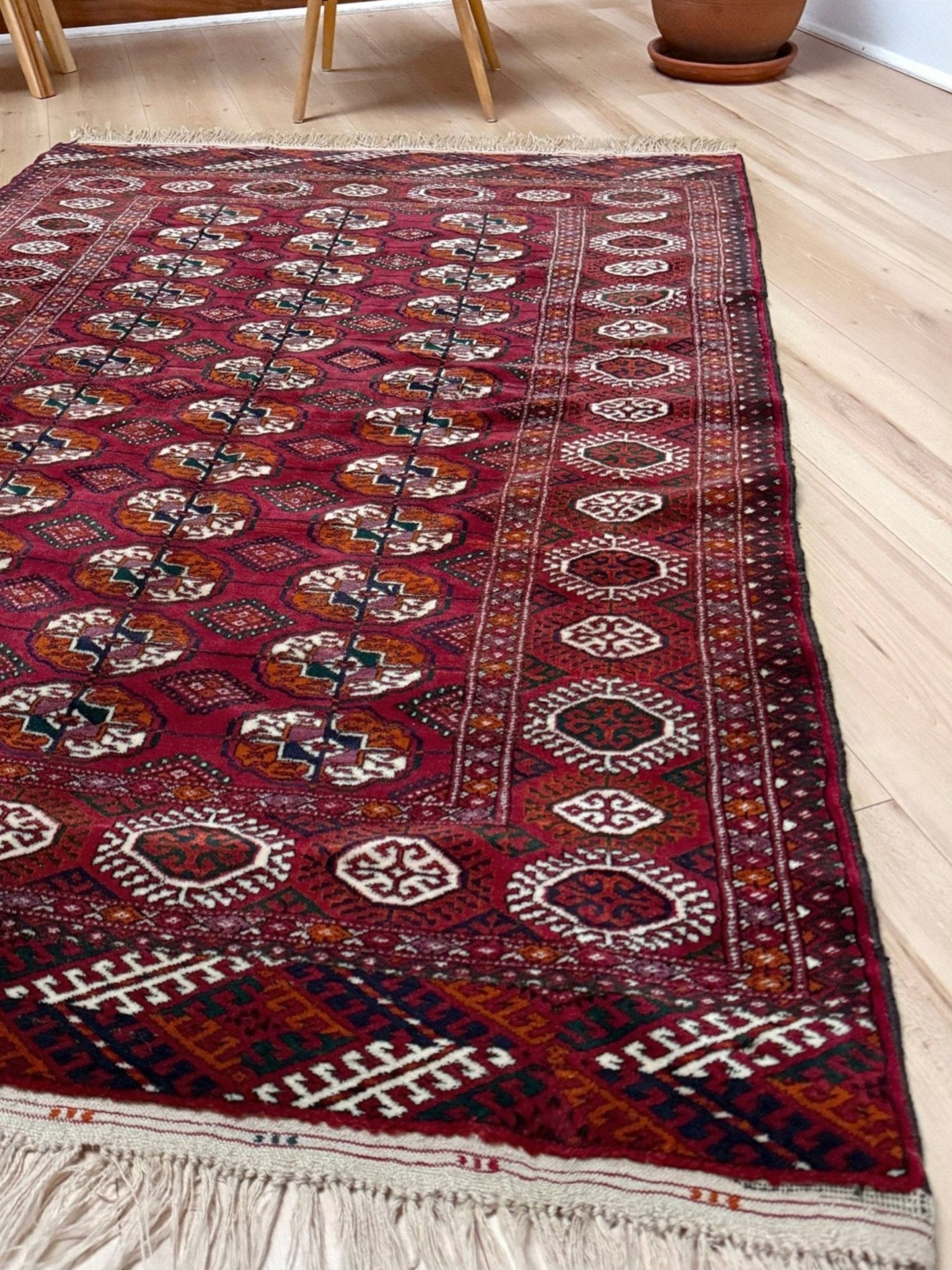Vintage Turkmen Burgundy Bukhara rug 4x6 with repeating ivory gul motifs, velvety wool pile and classic tribal border. Hand-knotted wool decorative scatter rug for living room bedroom office from Indigo Rugs, Burlingame — the best rug shop in the San Francisco Bay Area. Free shipping.