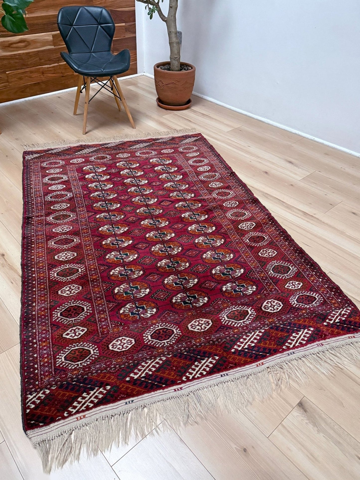 Vintage Turkmen Burgundy Bukhara rug 4x6 with repeating ivory gul motifs, velvety wool pile and classic tribal border. Hand-knotted wool decorative scatter rug for living room bedroom office from Indigo Rugs, Burlingame — the best rug shop in the San Francisco Bay Area. Free shipping.