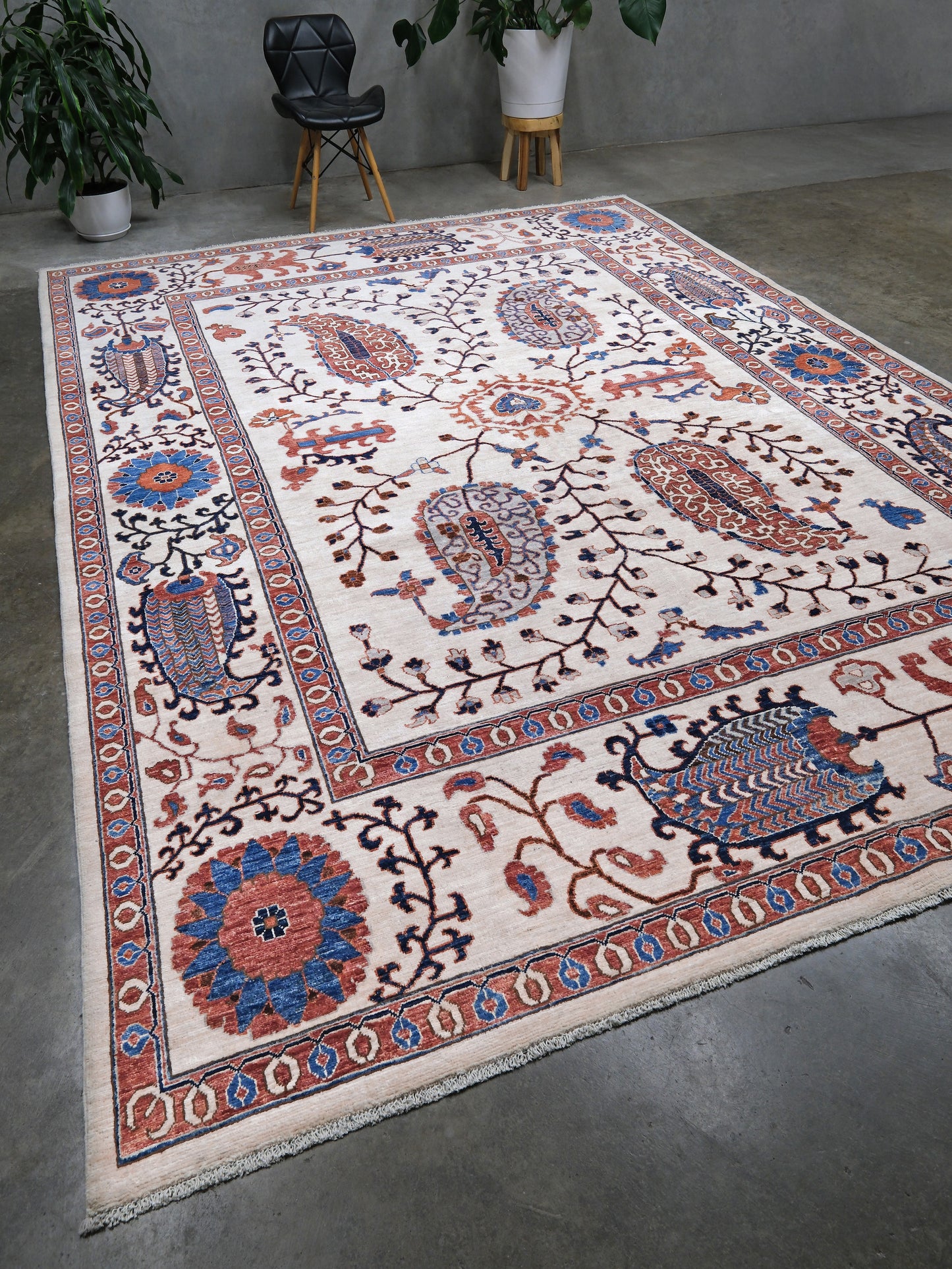 Ivory Suzani style handmade Turkish wool rug with paisley motifs, branching vines, flowers, indigo blue and rust accents, 9x12 from Indigo Rugs Burlingame Bay Area.