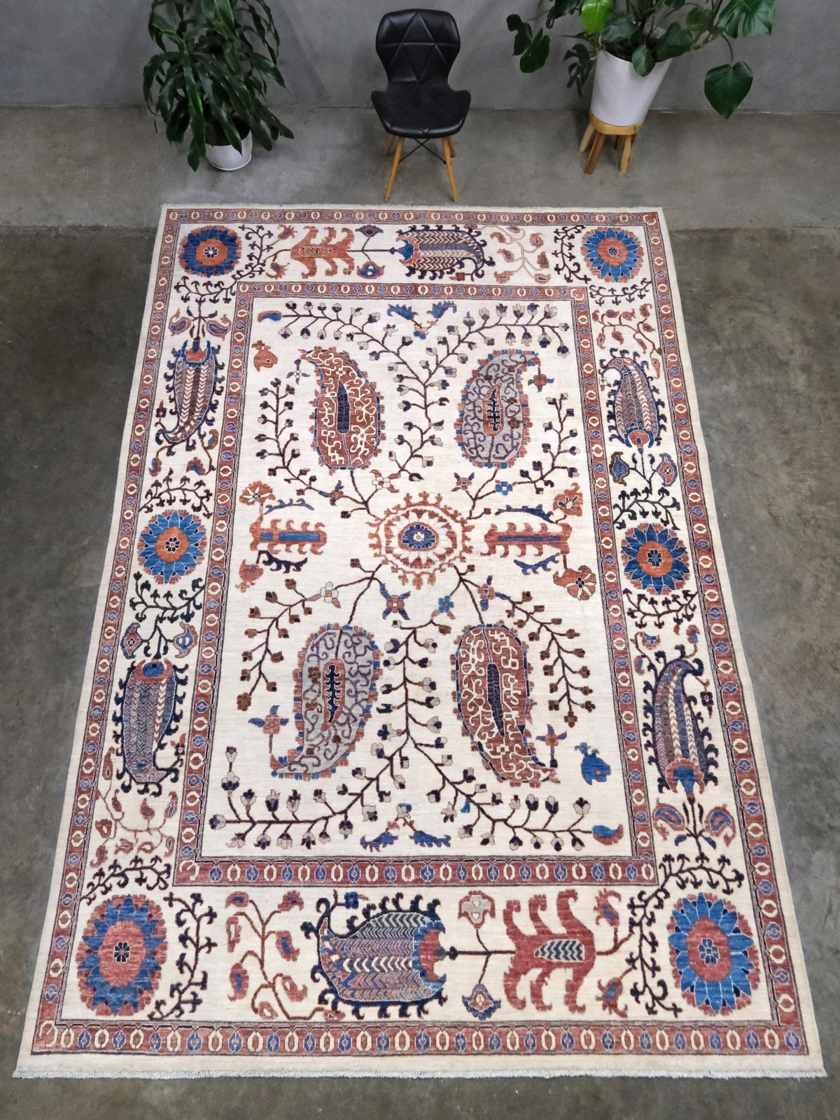 Ivory Suzani style handmade Turkish wool rug with paisley motifs, branching vines, flowers, indigo blue and rust accents, 9x12 from Indigo Rugs Burlingame Bay Area.