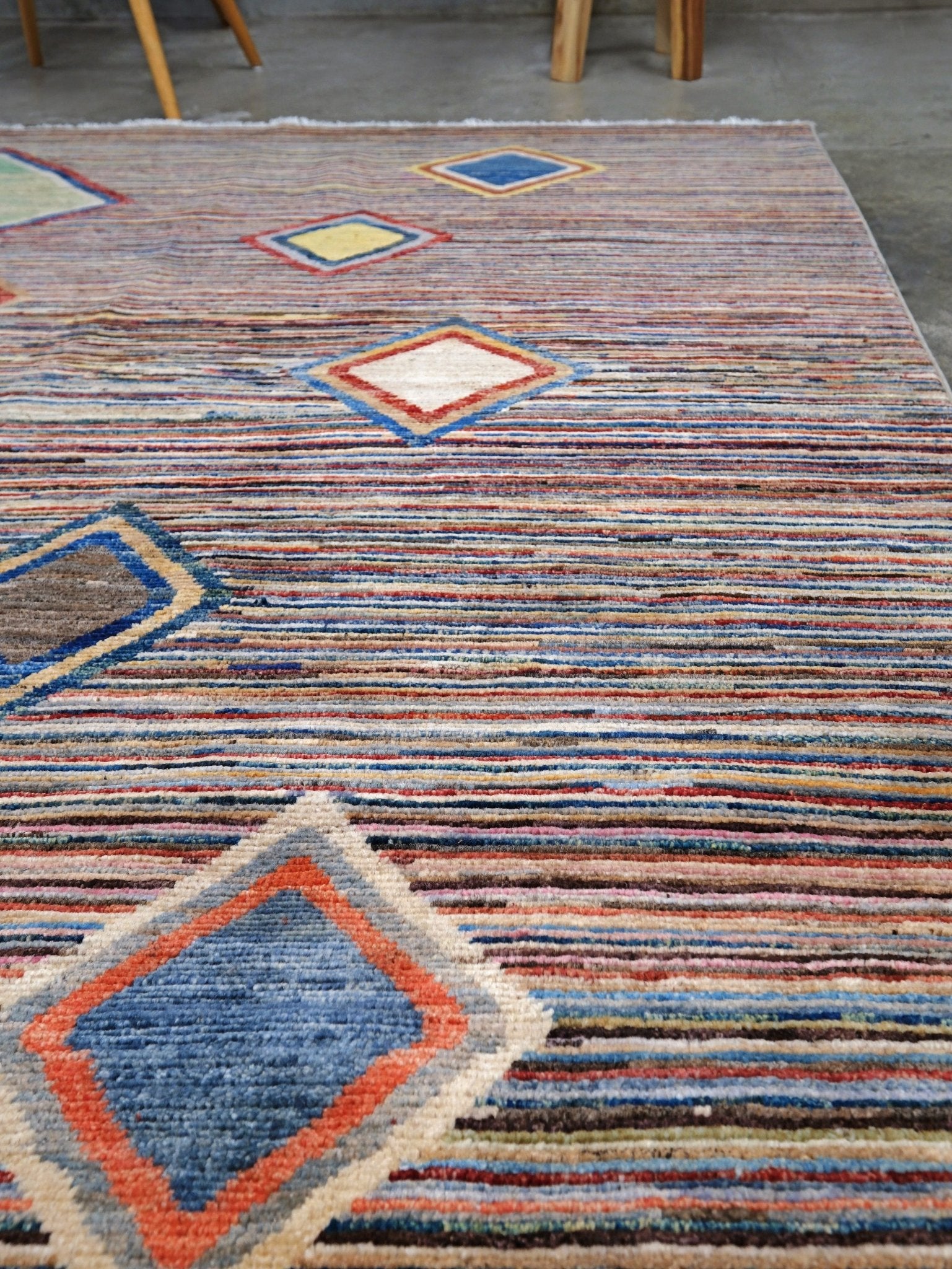 Modern Turkish Gabbeh style handmade wool rug with colorful diamond medallions on a striped field in blue, red, ivory, gray, green, camel and lavender, 7x10 from Indigo Rugs Burlingame Bay Area.