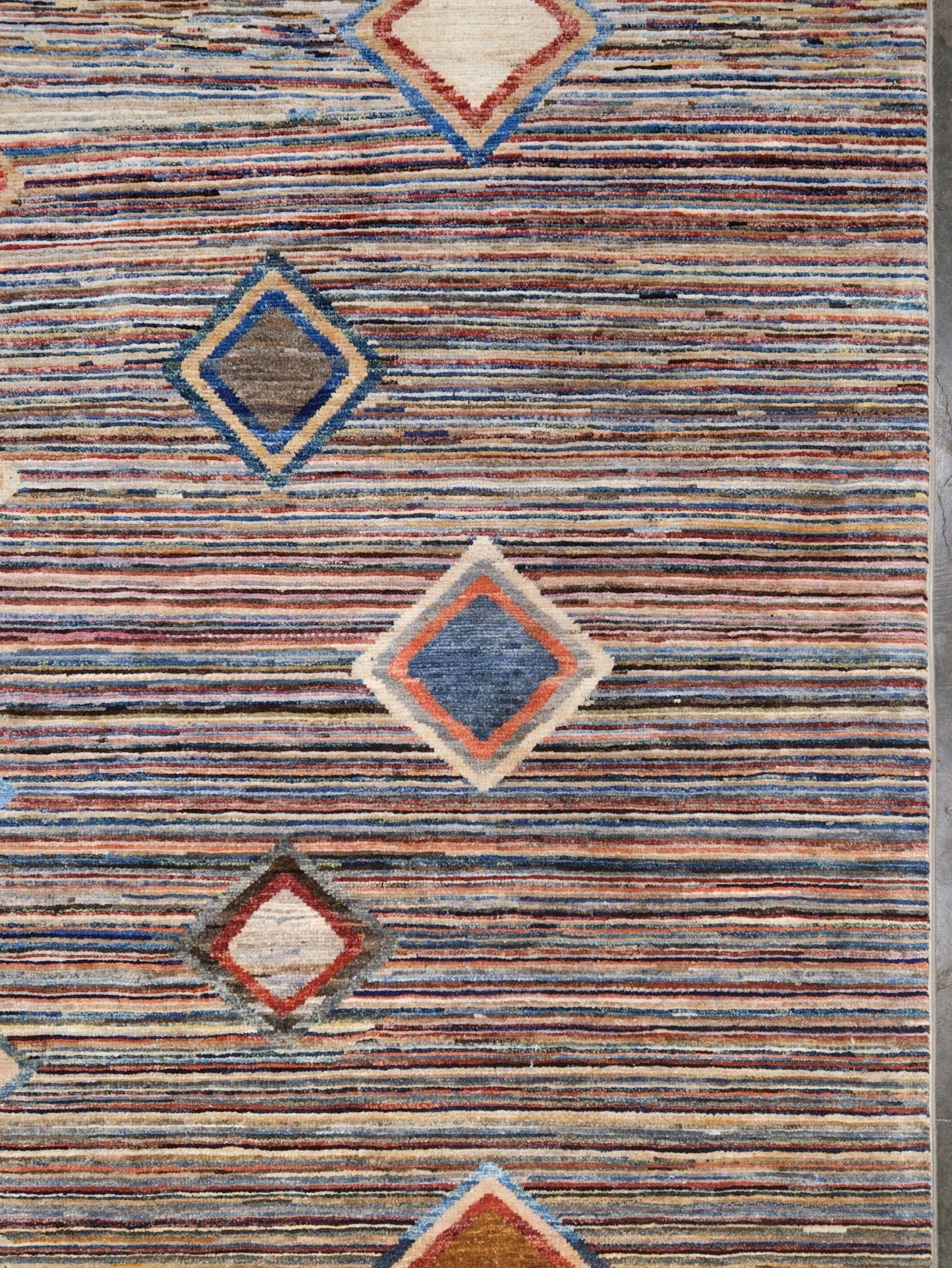 Modern Turkish Gabbeh style handmade wool rug with colorful diamond medallions on a striped field in blue, red, ivory, gray, green, camel and lavender, 7x10 from Indigo Rugs Burlingame Bay Area.