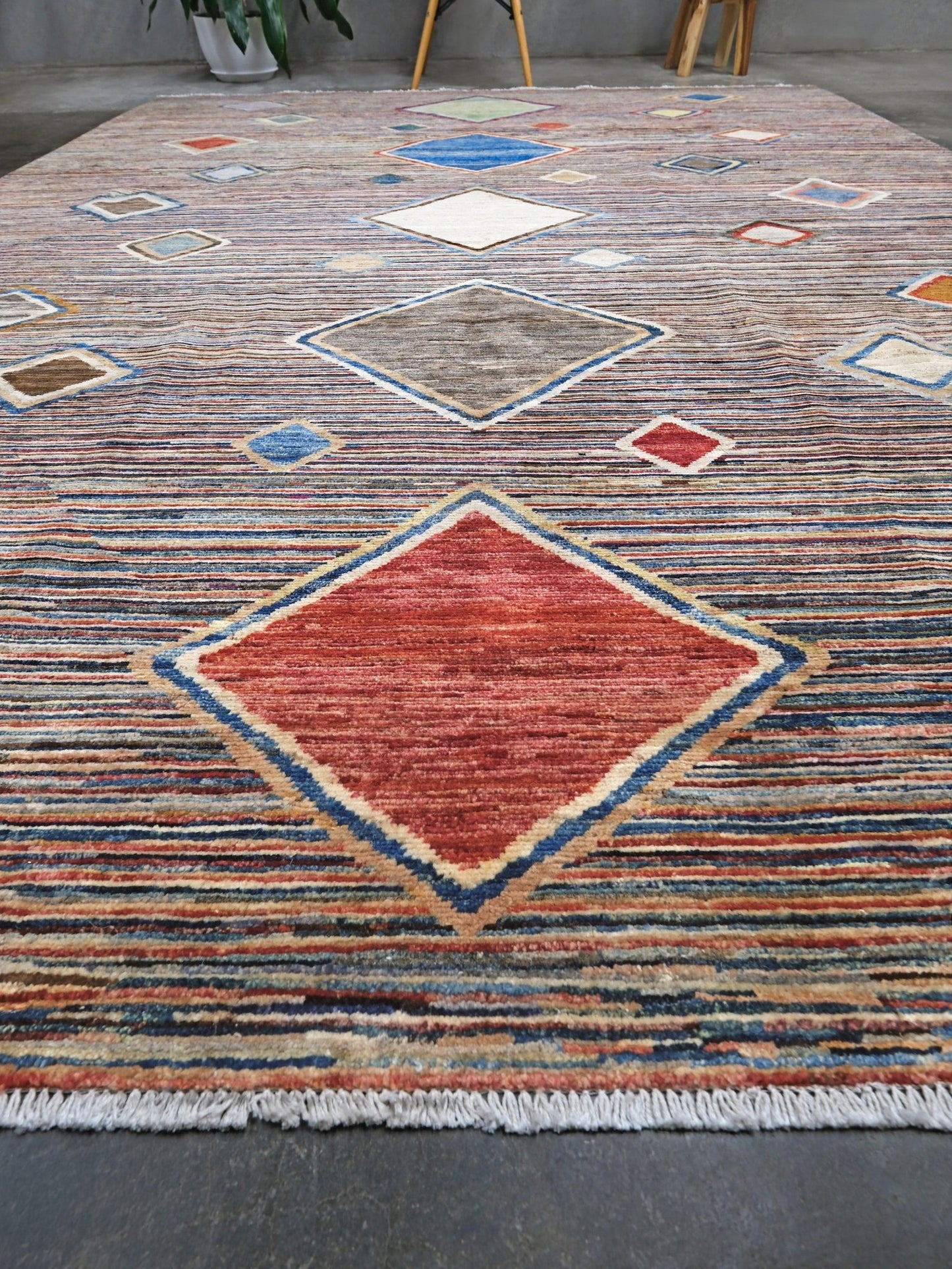 Modern Turkish Gabbeh style handmade wool rug with colorful diamond medallions on a striped field in blue, red, ivory, gray, green, camel and lavender, 7x10 from Indigo Rugs Burlingame Bay Area.