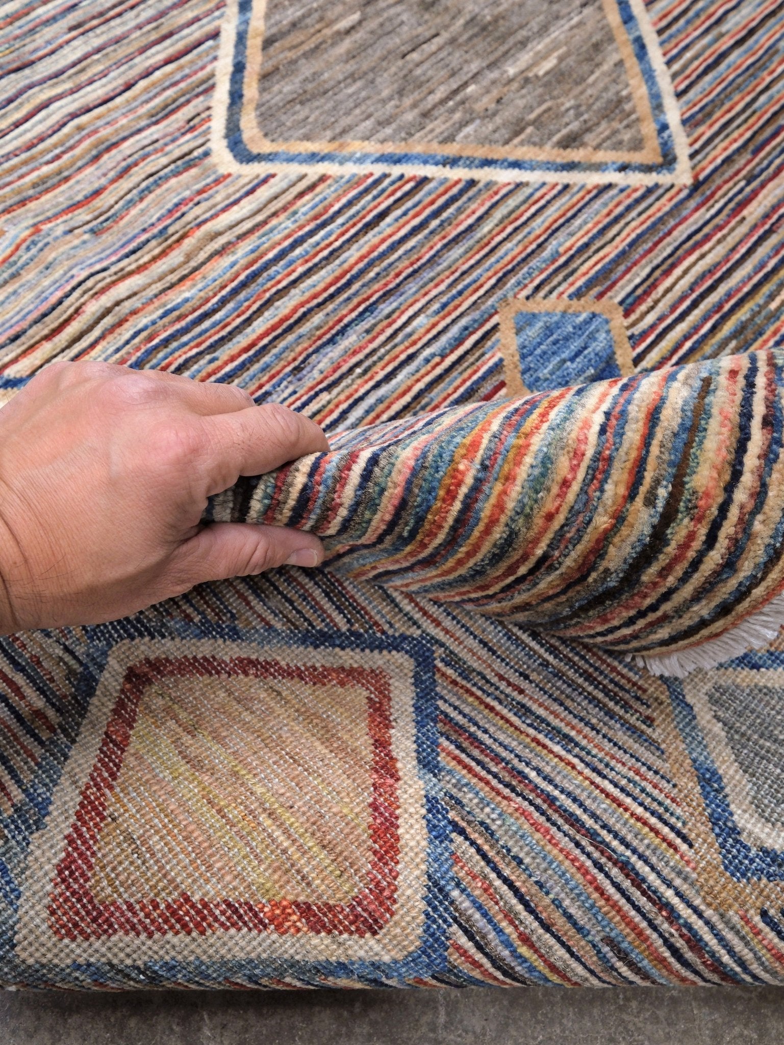 Modern Turkish Gabbeh style handmade wool rug with colorful diamond medallions on a striped field in blue, red, ivory, gray, green, camel and lavender, 7x10 from Indigo Rugs Burlingame Bay Area.