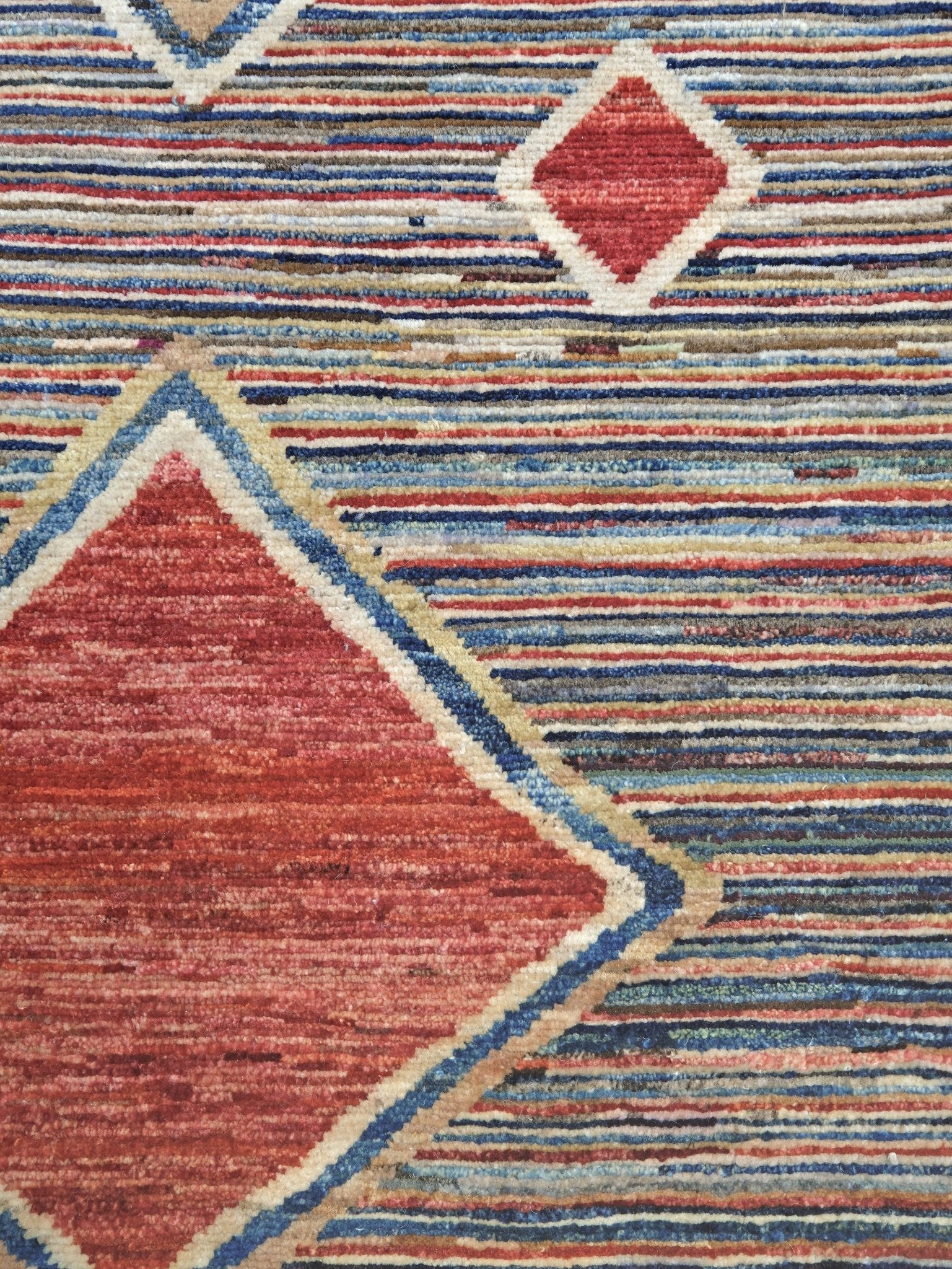 Modern Turkish Gabbeh style handmade wool rug with colorful diamond medallions on a striped field in blue, red, ivory, gray, green, camel and lavender, 7x10 from Indigo Rugs Burlingame Bay Area.
