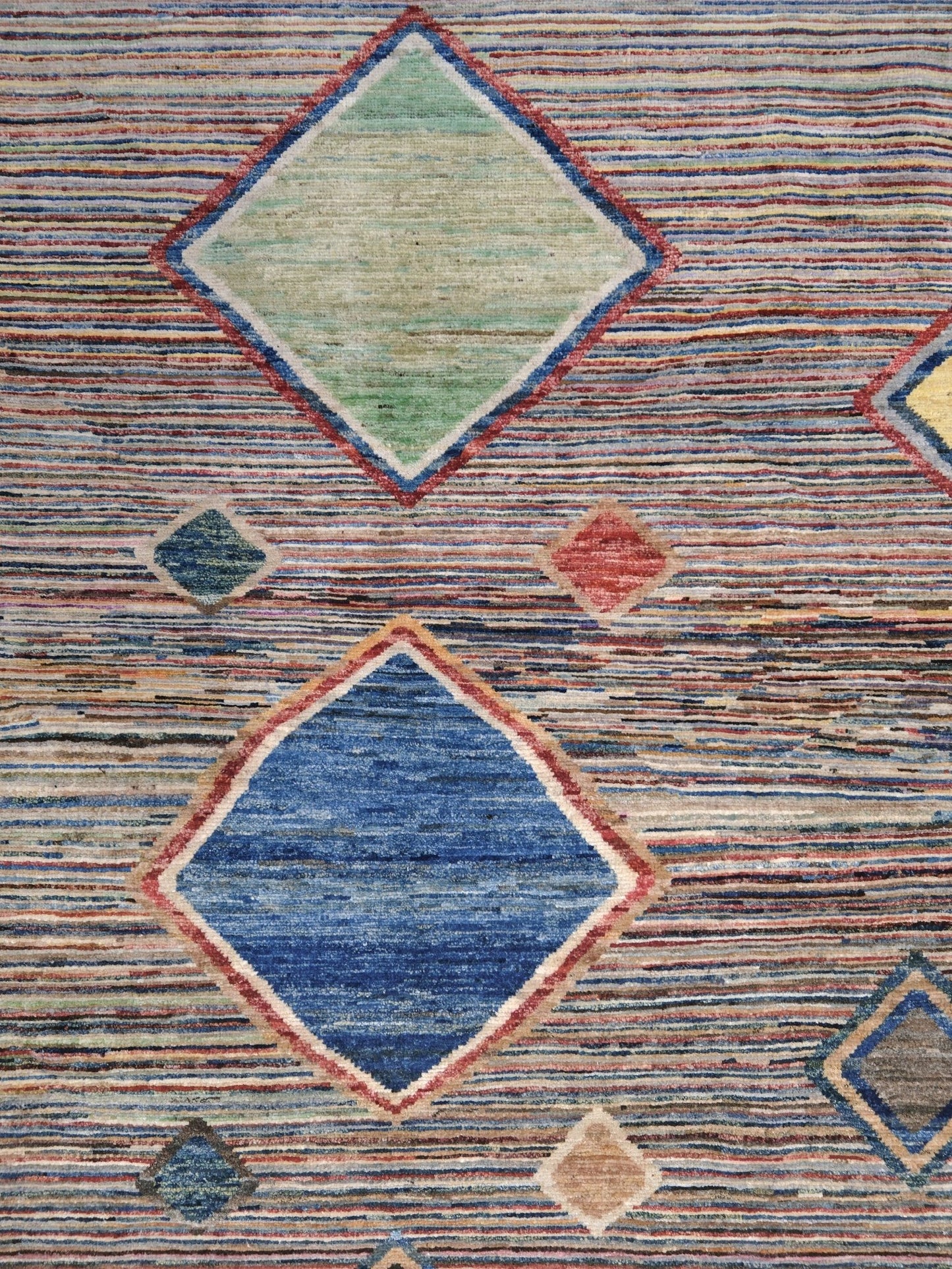 Modern Turkish Gabbeh style handmade wool rug with colorful diamond medallions on a striped field in blue, red, ivory, gray, green, camel and lavender, 7x10 from Indigo Rugs Burlingame Bay Area.