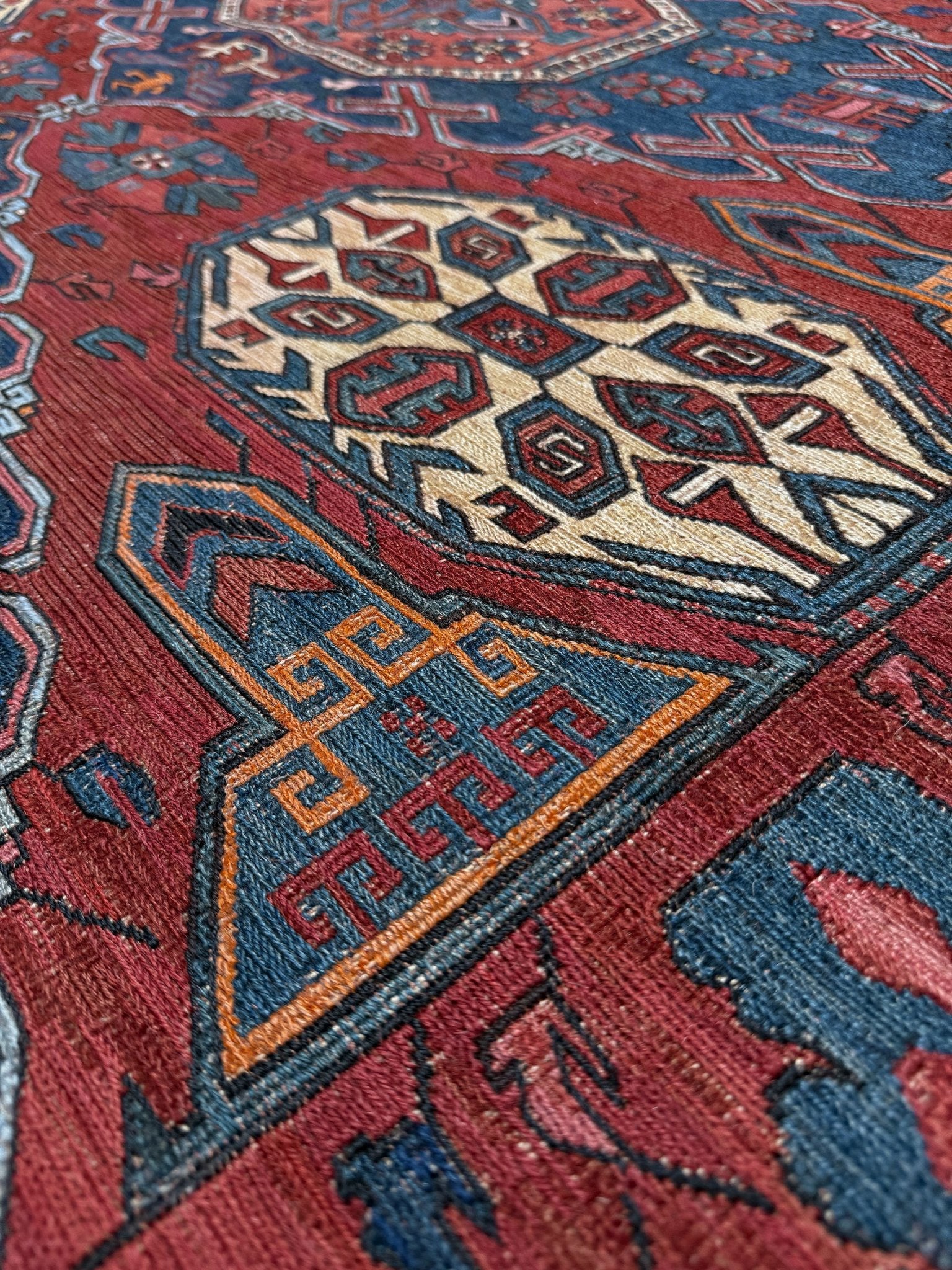 Antique Caucasian Soumak rug with madder red and indigo blue geometric medallions, woven in the South Caucasus circa 1925, available at top-rated rug shop in San Mateo, SF Bay Area with free shipping.
