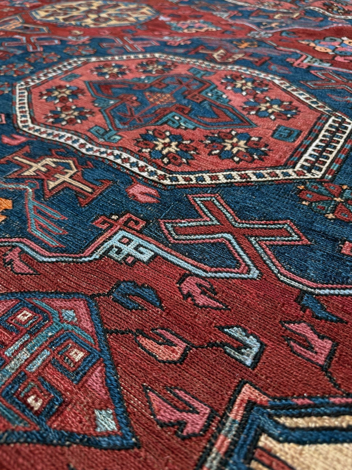 Antique Caucasian Soumak rug with madder red and indigo blue geometric medallions, woven in the South Caucasus circa 1925, available at top-rated rug shop in San Mateo, SF Bay Area with free shipping.