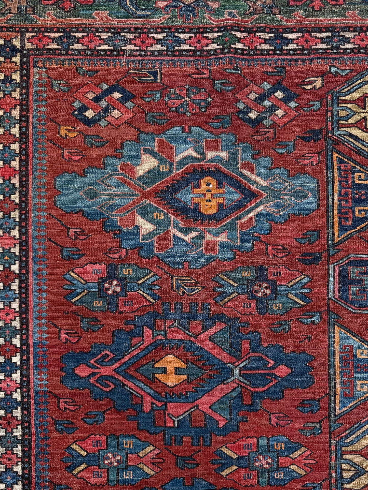 Antique Caucasian Soumak rug with madder red and indigo blue geometric medallions, woven in the South Caucasus circa 1925, available at top-rated rug shop in San Mateo, SF Bay Area with free shipping.