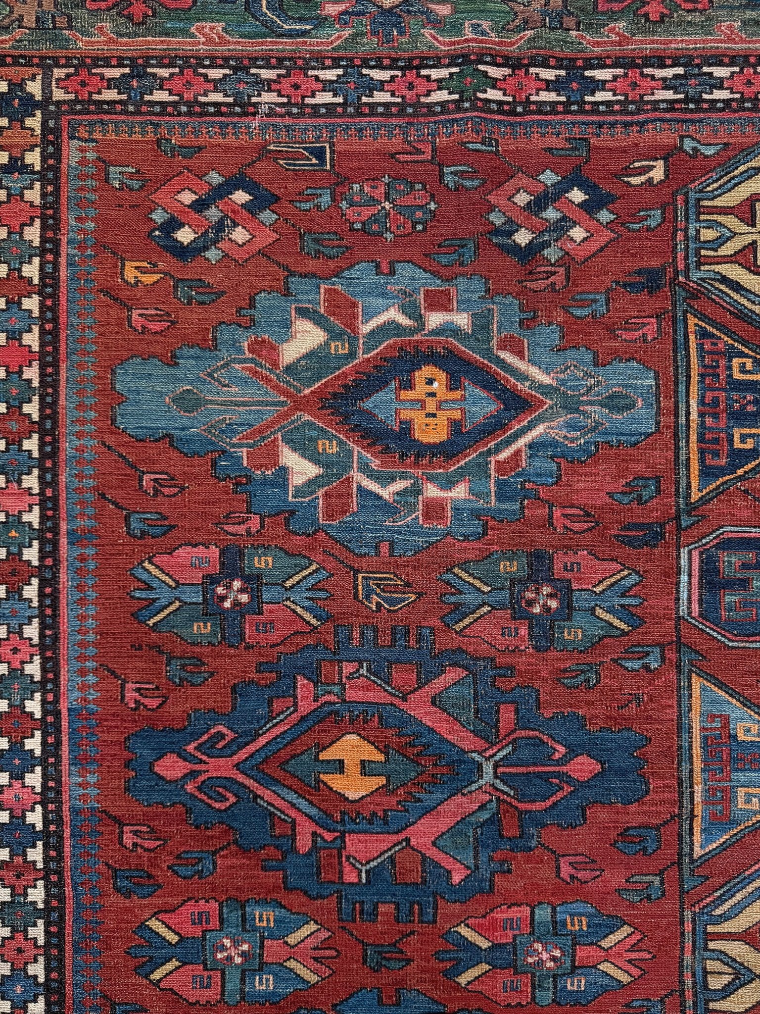 Antique Caucasian Soumak rug with madder red and indigo blue geometric medallions, woven in the South Caucasus circa 1925, available at top-rated rug shop in San Mateo, SF Bay Area with free shipping.