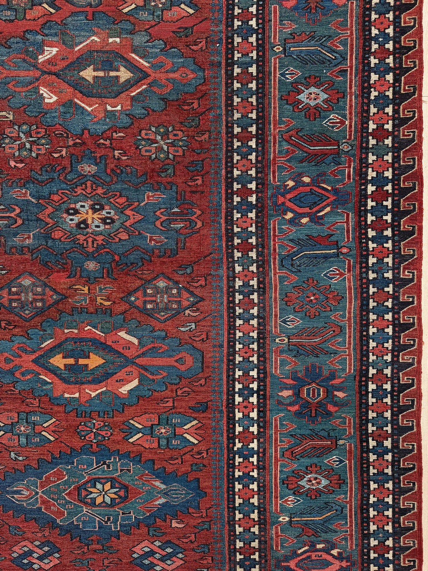 Antique Caucasian Soumak rug with madder red and indigo blue geometric medallions, woven in the South Caucasus circa 1925, available at top-rated rug shop in San Mateo, SF Bay Area with free shipping.