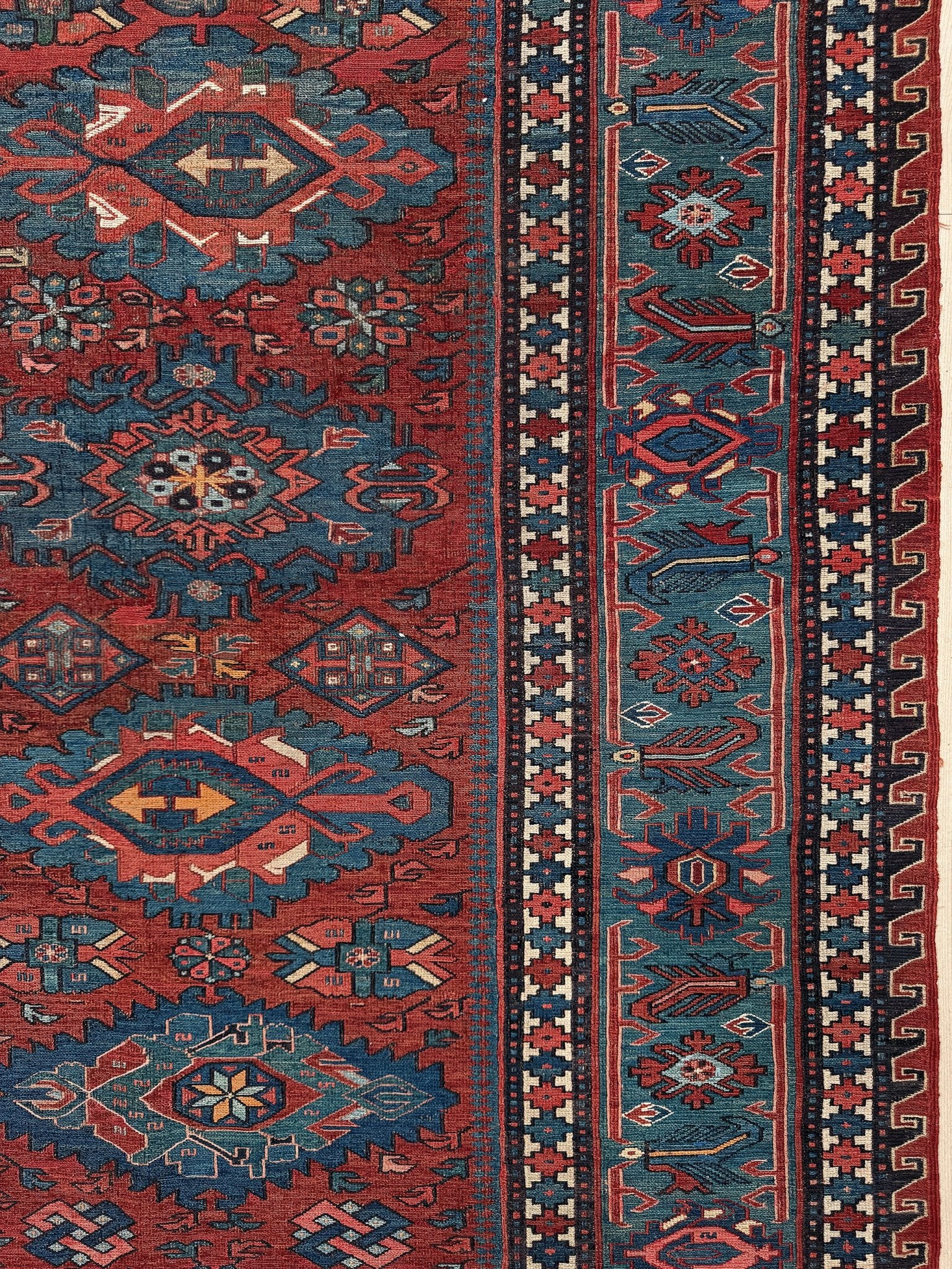 Antique Caucasian Soumak rug with madder red and indigo blue geometric medallions, woven in the South Caucasus circa 1925, available at top-rated rug shop in San Mateo, SF Bay Area with free shipping.