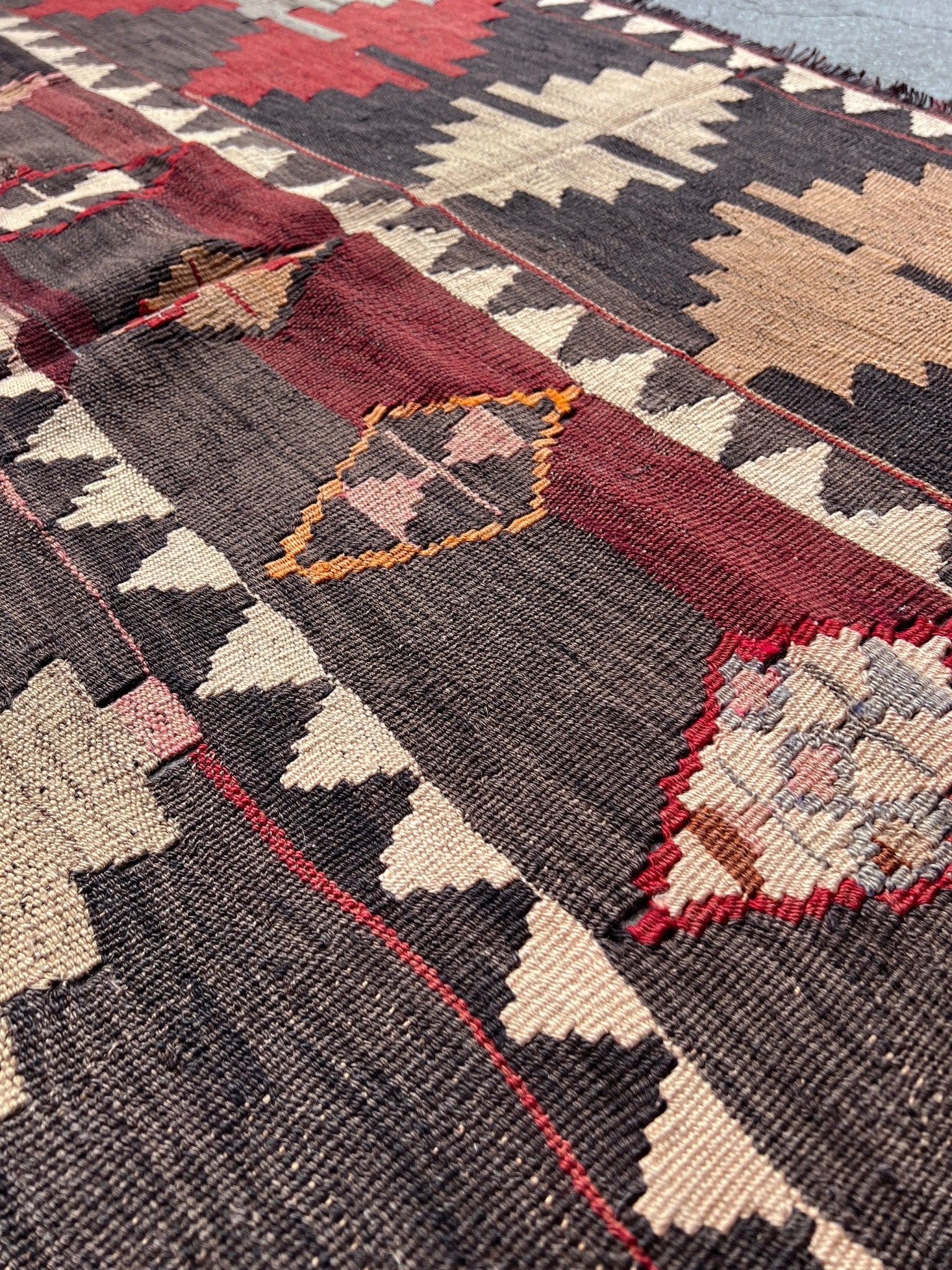 5x7 Kurdish Kilim rug from Eastern Turkey in slitweave technique, featuring bold geometric patterns in red, pink, and earthy tones. Offered by the best Kilim rug store in the San Francisco Bay Area, with free shipping to the US and Canada. A perfect gift idea for this season.