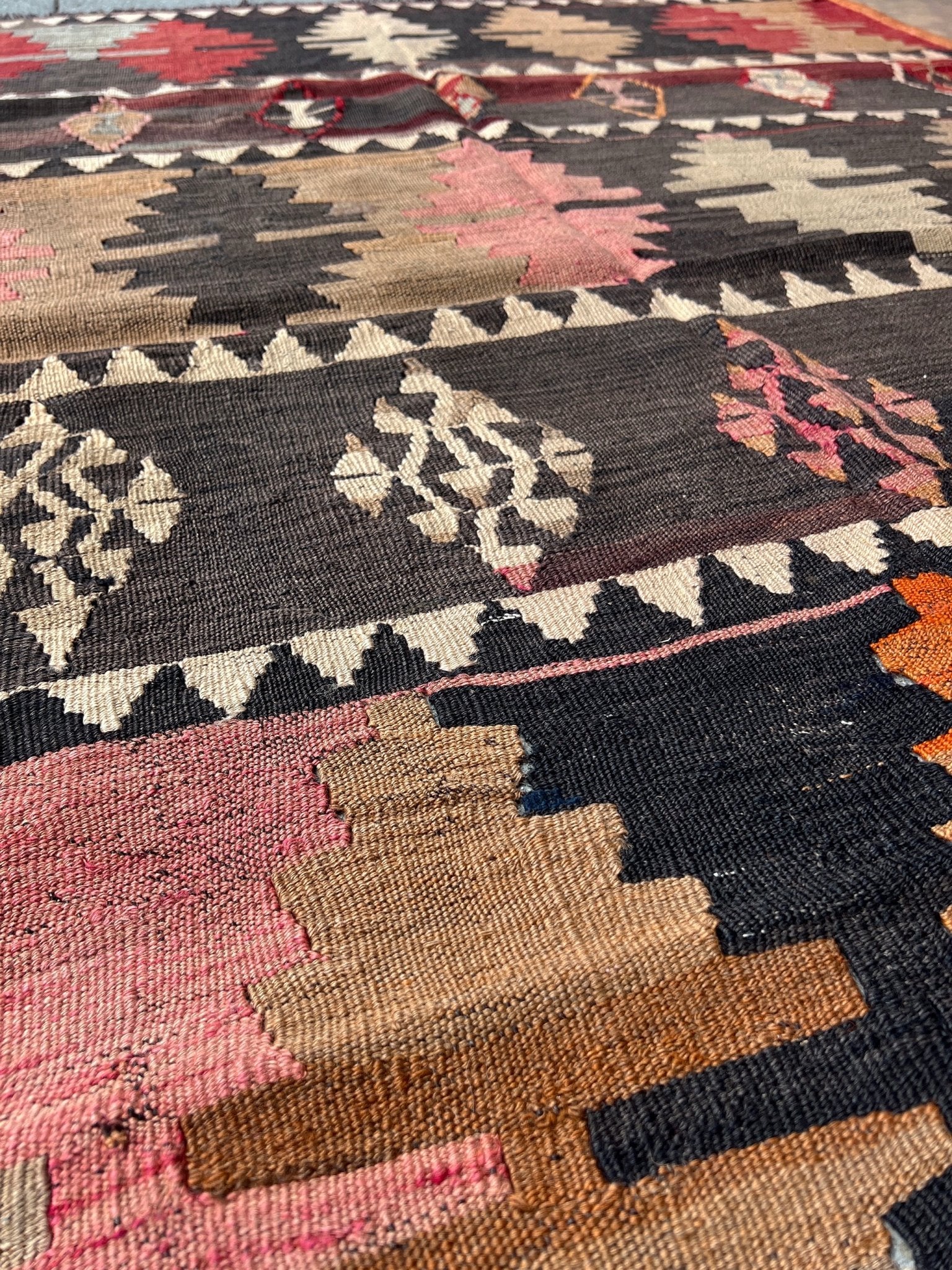 5x7 Kurdish Kilim rug from Eastern Turkey in slitweave technique, featuring bold geometric patterns in red, pink, and earthy tones. Offered by the best Kilim rug store in the San Francisco Bay Area, with free shipping to the US and Canada. A perfect gift idea for this season.