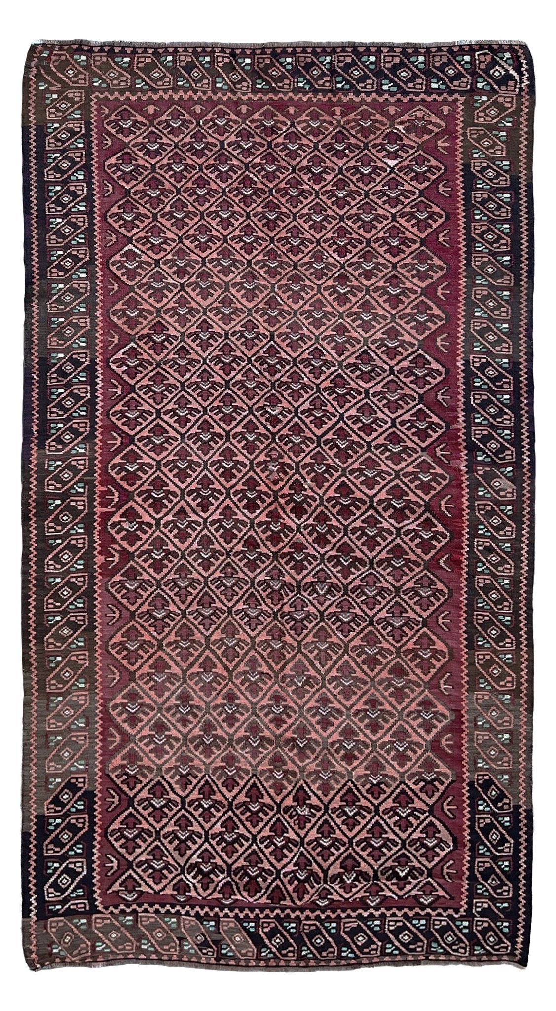 Traditional patterned rug with intricate design on a plain background. Vintage Caucasian kilim rug with dusty rose lattice field and tribal animal motifs, handwoven wool flatweave 5x10 runner size from Indigo Rugs Burlingame California