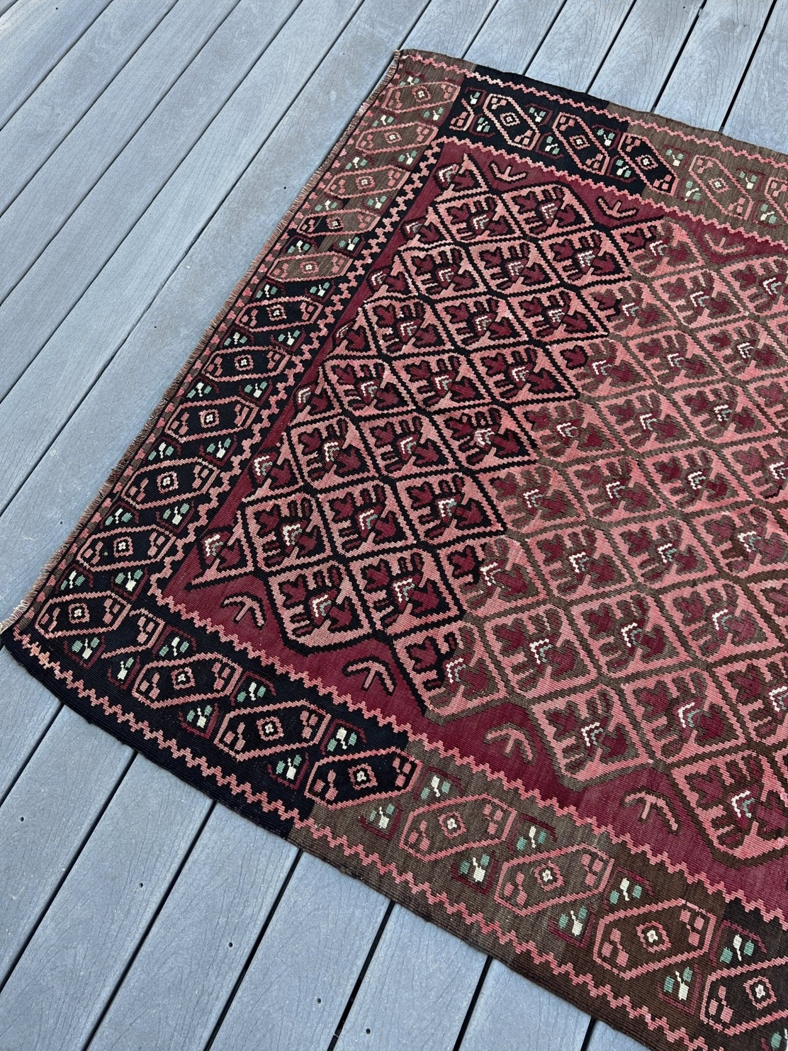 Vintage Caucasian kilim rug with wine red and dusty rose lattice field and tribal animal motifs, handwoven wool flatweave 5x10 runner size from Indigo Rugs Burlingame California