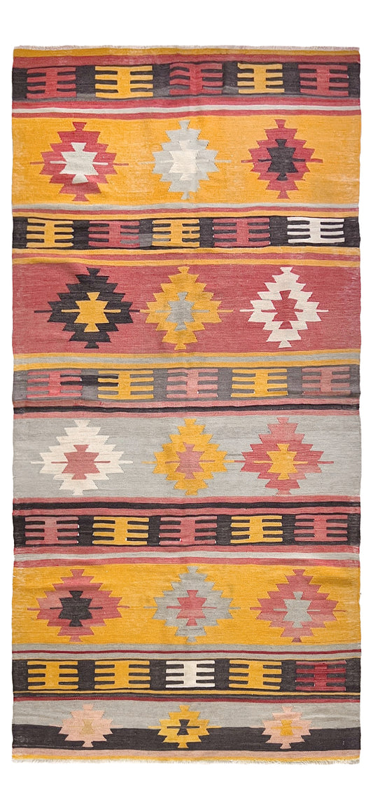 Colorful patterned rug with geometric designs on a plain background. Vintage Afyon Turkish kilim runner, 4x9, with striped tribal design in muted brick red, dusty rose, bright marigold, and charcoal tones.