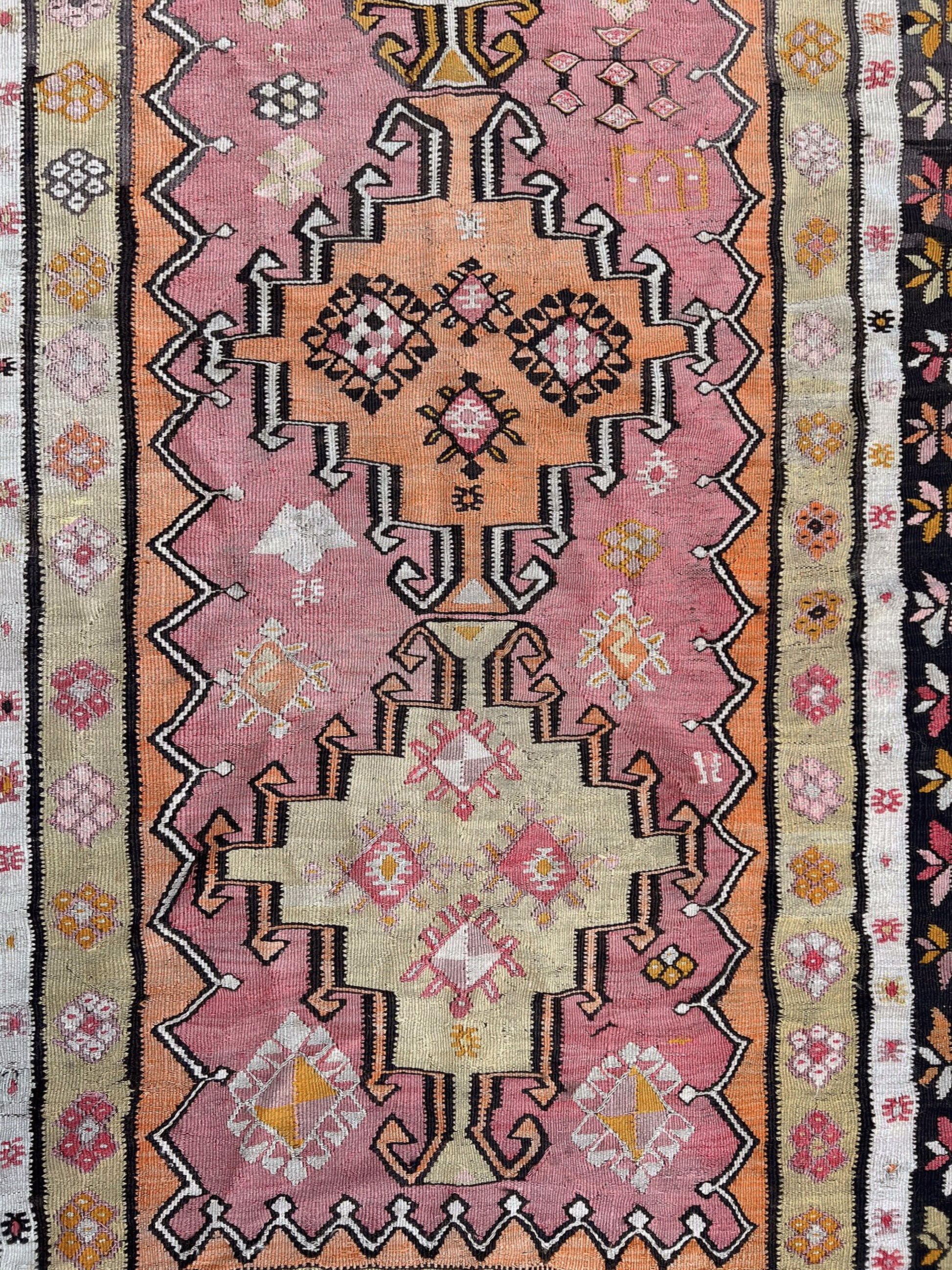 Vintage Kurdish runner rug from Eastern Turkey, 4x10, with dusty rose and peach medallions, floral borders, and woven inscription dated 1948.
