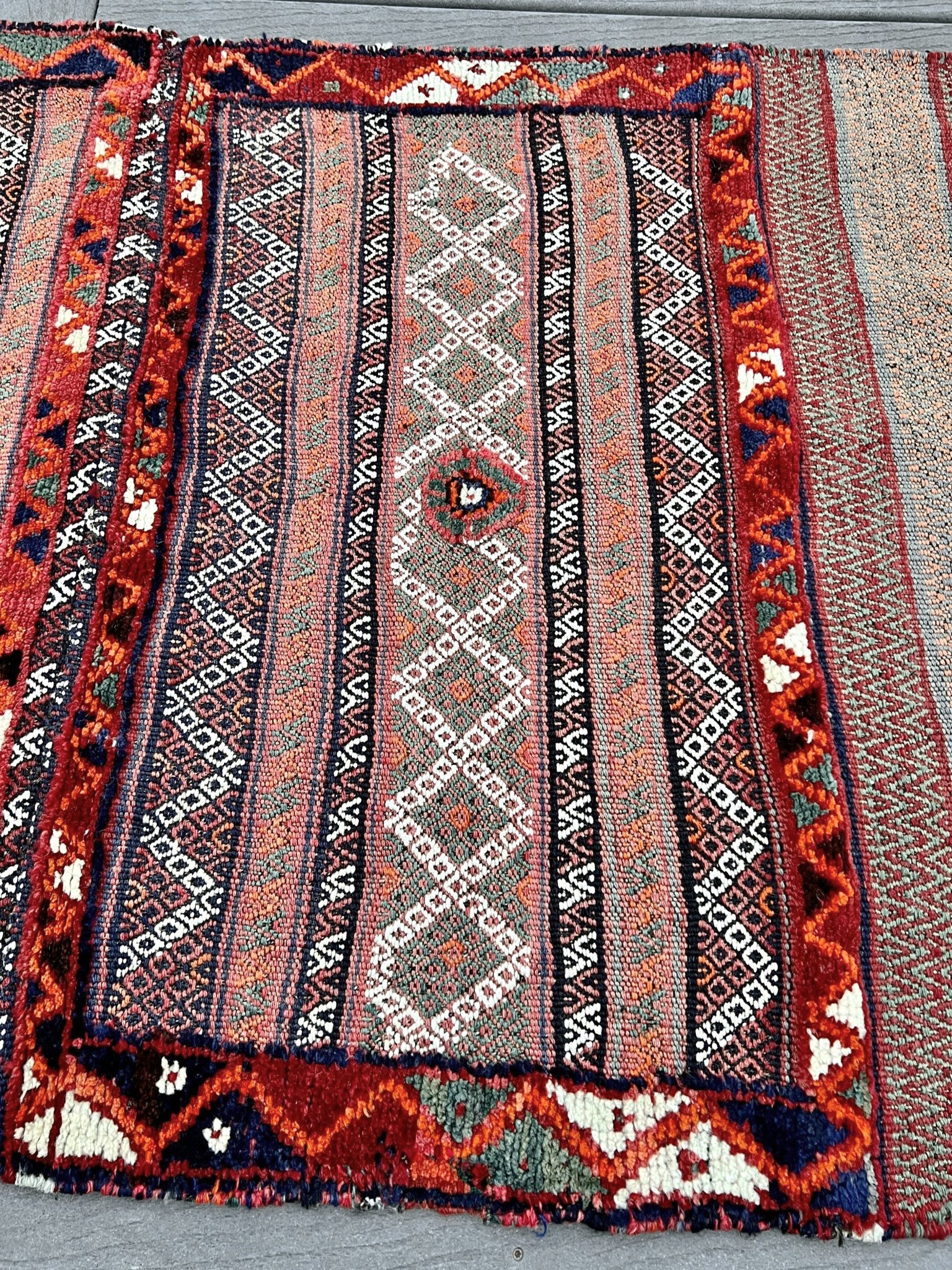 Vintage Bakhtiari khorjin saddle bag wall art rug (3'x6'7") featuring terracotta and ivory diamond motifs, olive and charcoal tribal patterns, and rare triple-weave structure — handmade in NW Persia, circa 1940s