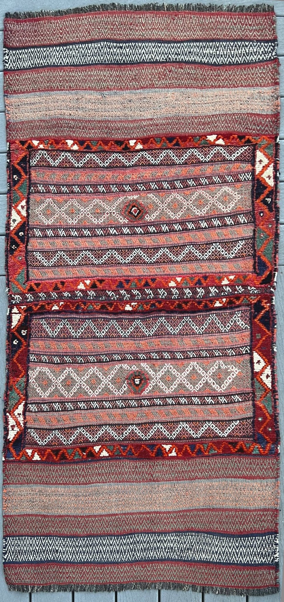 Vintage Bakhtiari khorjin saddle bag wall art rug (3'x6'7") featuring terracotta and ivory diamond motifs, olive and charcoal tribal patterns, and rare triple-weave structure — handmade in NW Persia, circa 1940s