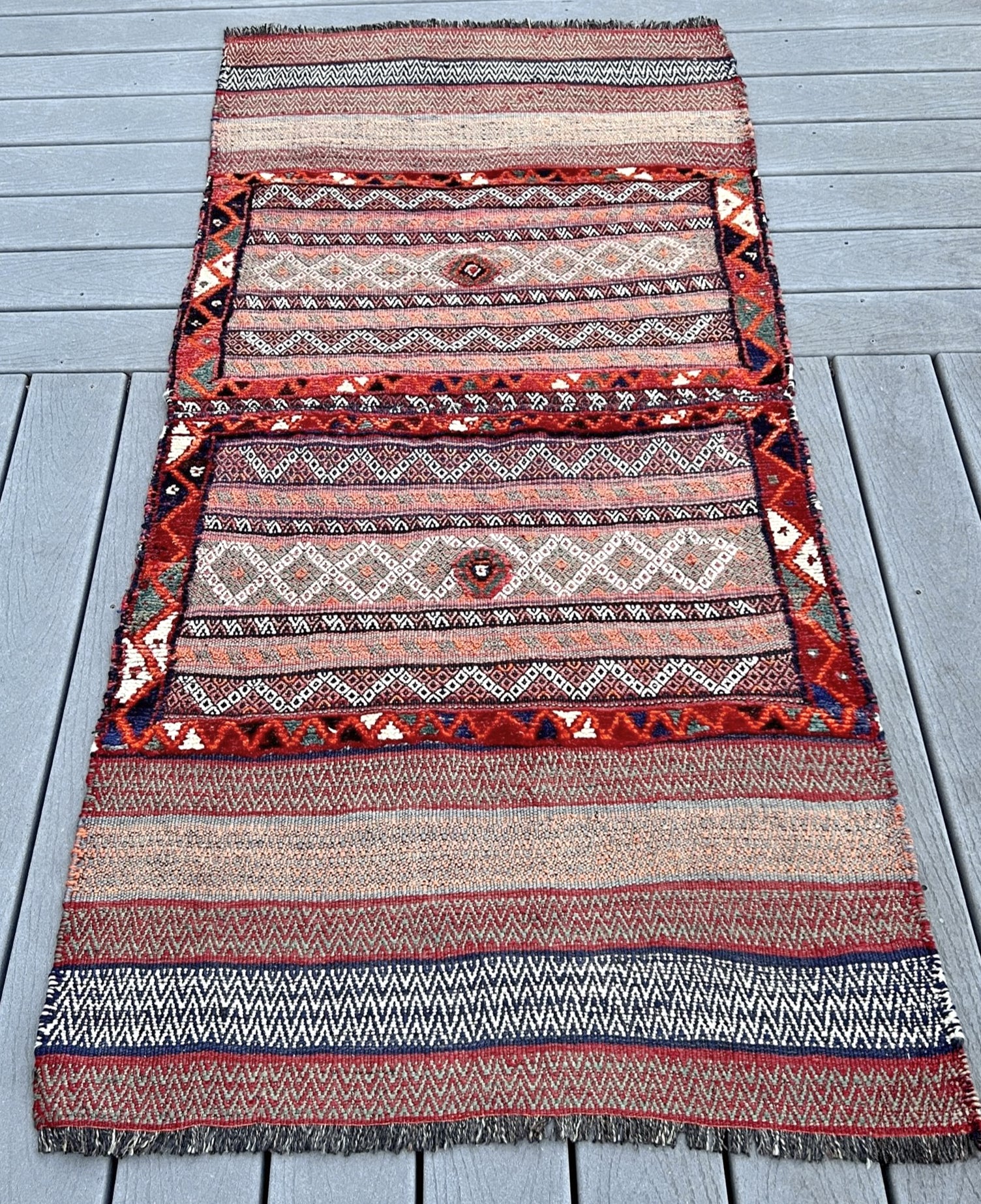 Vintage Bakhtiari khorjin saddle bag wall art rug (3'x6'7") featuring terracotta and ivory diamond motifs, olive and charcoal tribal patterns, and rare triple-weave structure — handmade in NW Persia, circa 1940s