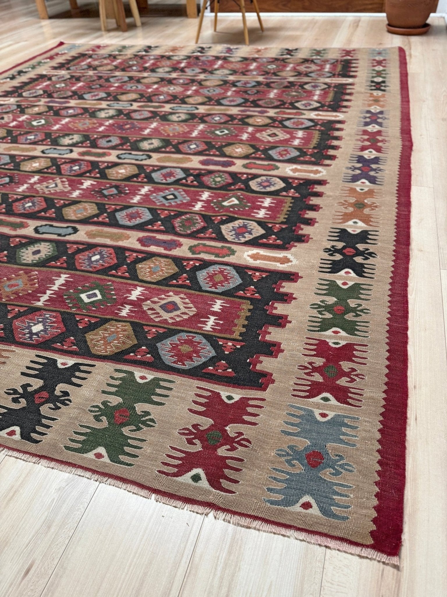 Handmade vintage Pirot Sharkoy kilim rug from the Balkans, approx. 8x10, with garnet red geometric bands, ivory tribal border, and charcoal, sage, and dusty blue motifs.