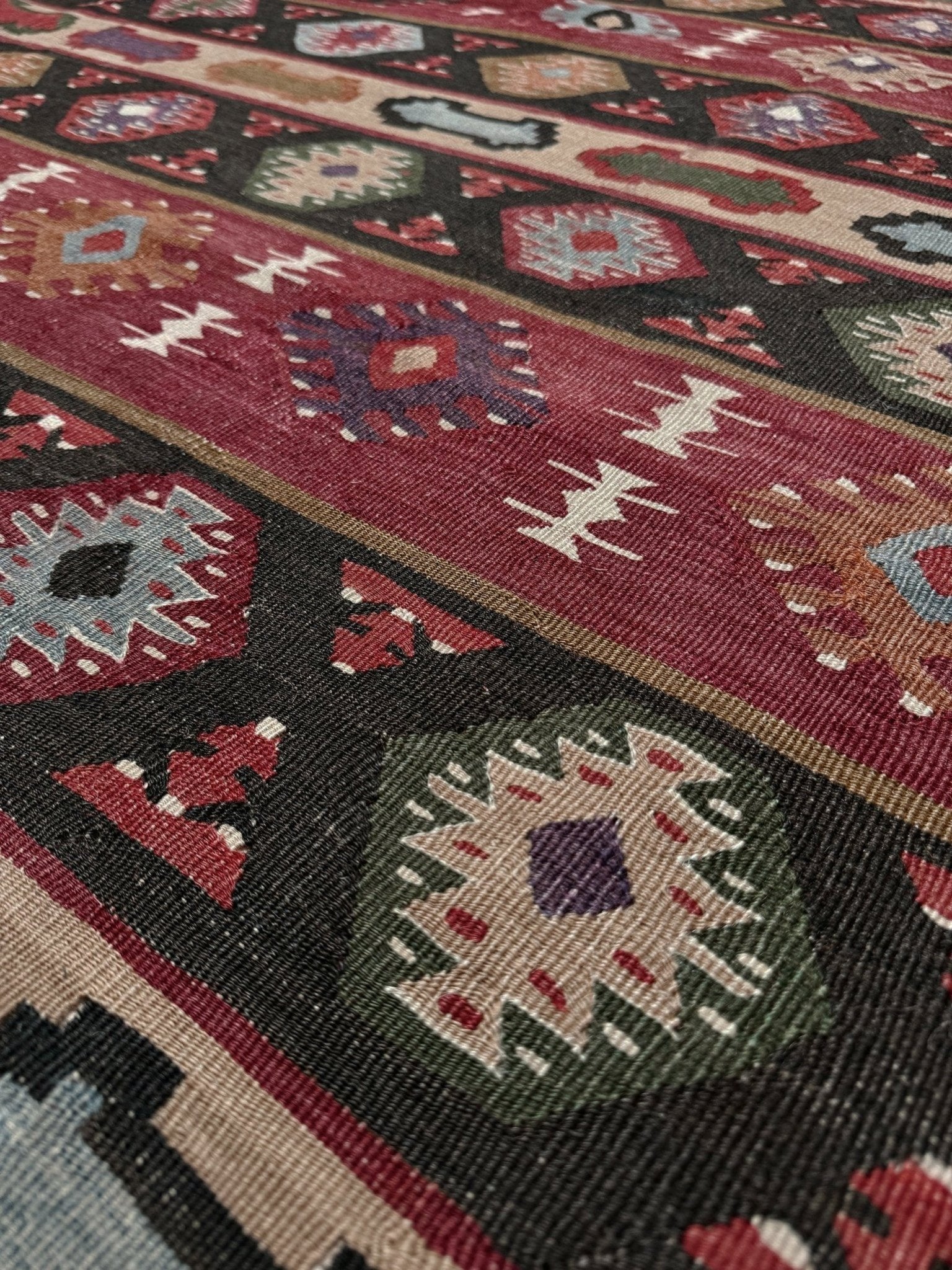 Handmade vintage Pirot Sharkoy kilim rug from the Balkans, approx. 8x10, with garnet red geometric bands, ivory tribal border, and charcoal, sage, and dusty blue motifs.