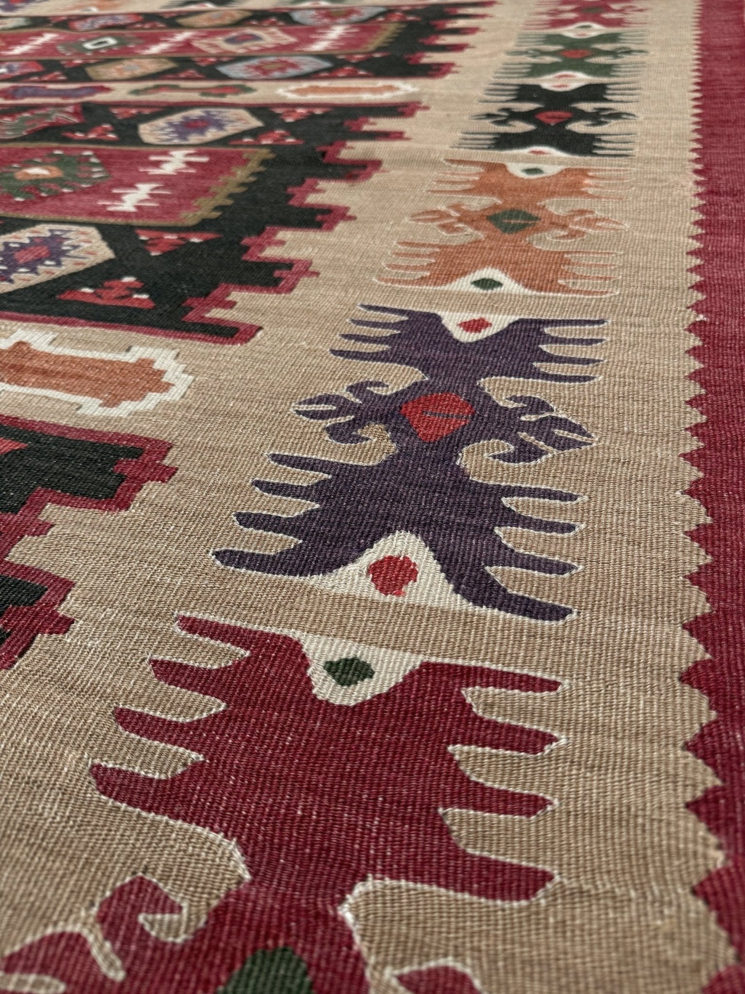 Handmade vintage Pirot Sharkoy kilim rug from the Balkans, approx. 8x10, with garnet red geometric bands, ivory tribal border, and charcoal, sage, and dusty blue motifs.
